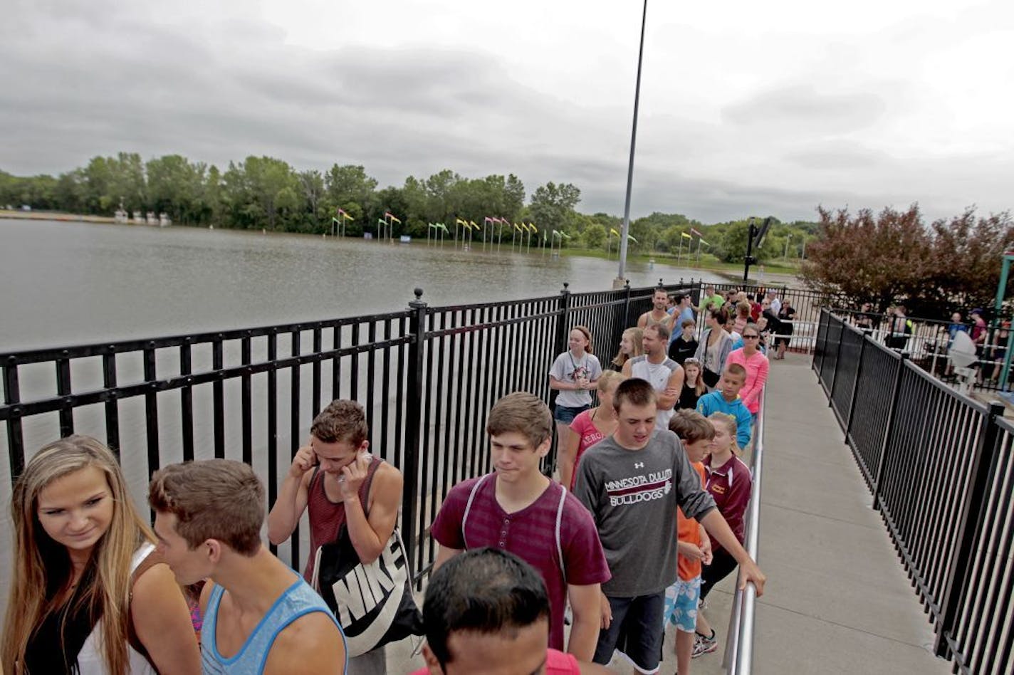 Valleyfair enthusiasts waited to hop on a ride near a flooded parking lot, Wednesday, June 25, 2014 in Shakopee. The parking lot and three rides were closed due to flooding; however, the rest of the park remained open.