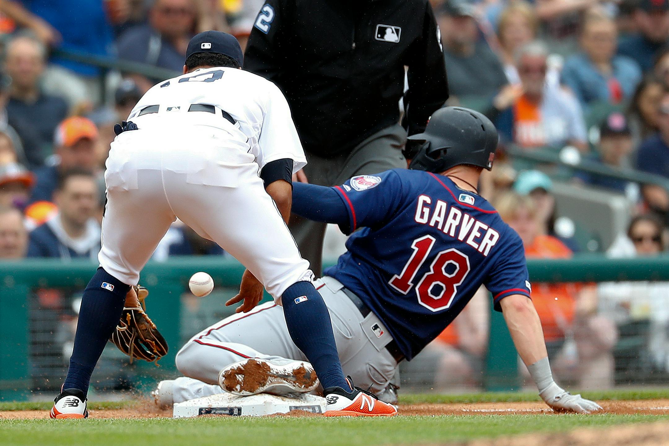 Minnesota Twins' Mitch Garver (18) slides safely into third base as Detroit Tigers third baseman Dawel Lugo loses the ball in the fourth inning of a baseball game in Detroit, Sunday, June 9, 2019. (AP Photo/Paul Sancya)