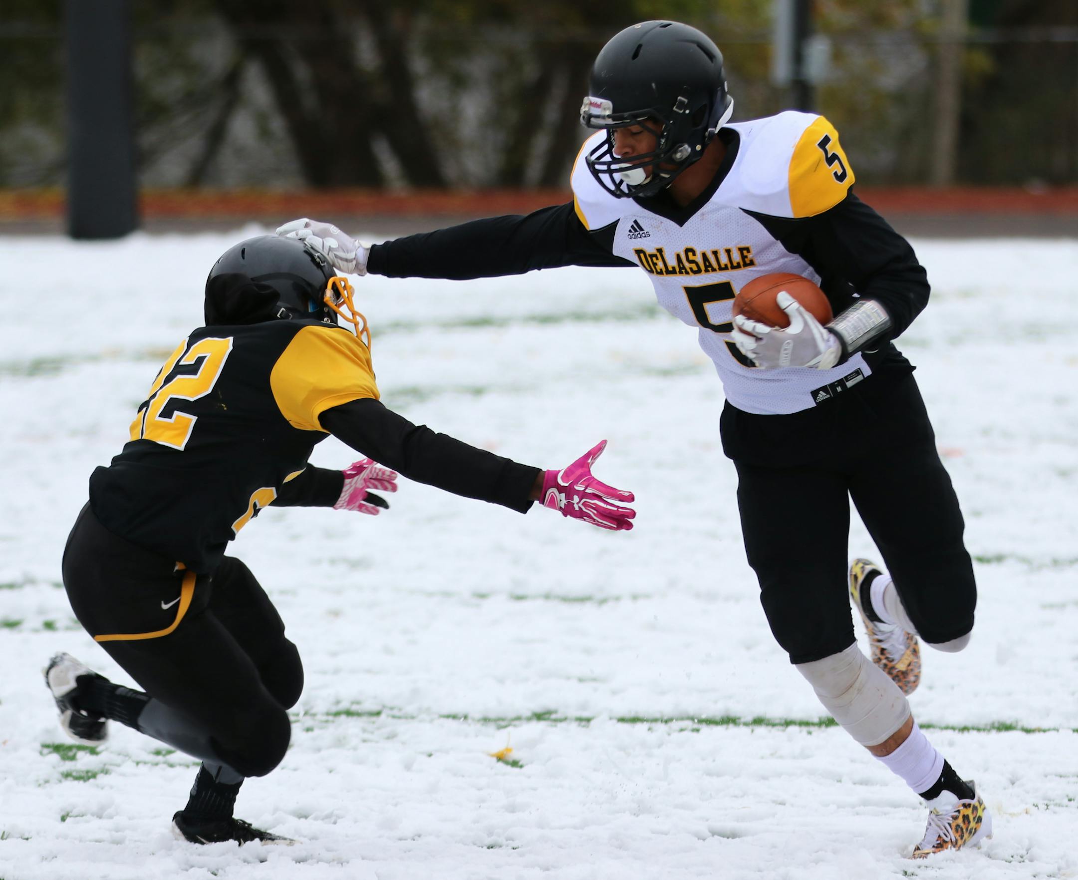 DeLaSalle senior Jevon Brekke (5) stiff arms a defender in the Islanders' 27-12 victory at St. Paul Como Park in the Class 4A, Section 4 semifinals. Brekke scored twice in the fouth quarter to lift his team to victory.