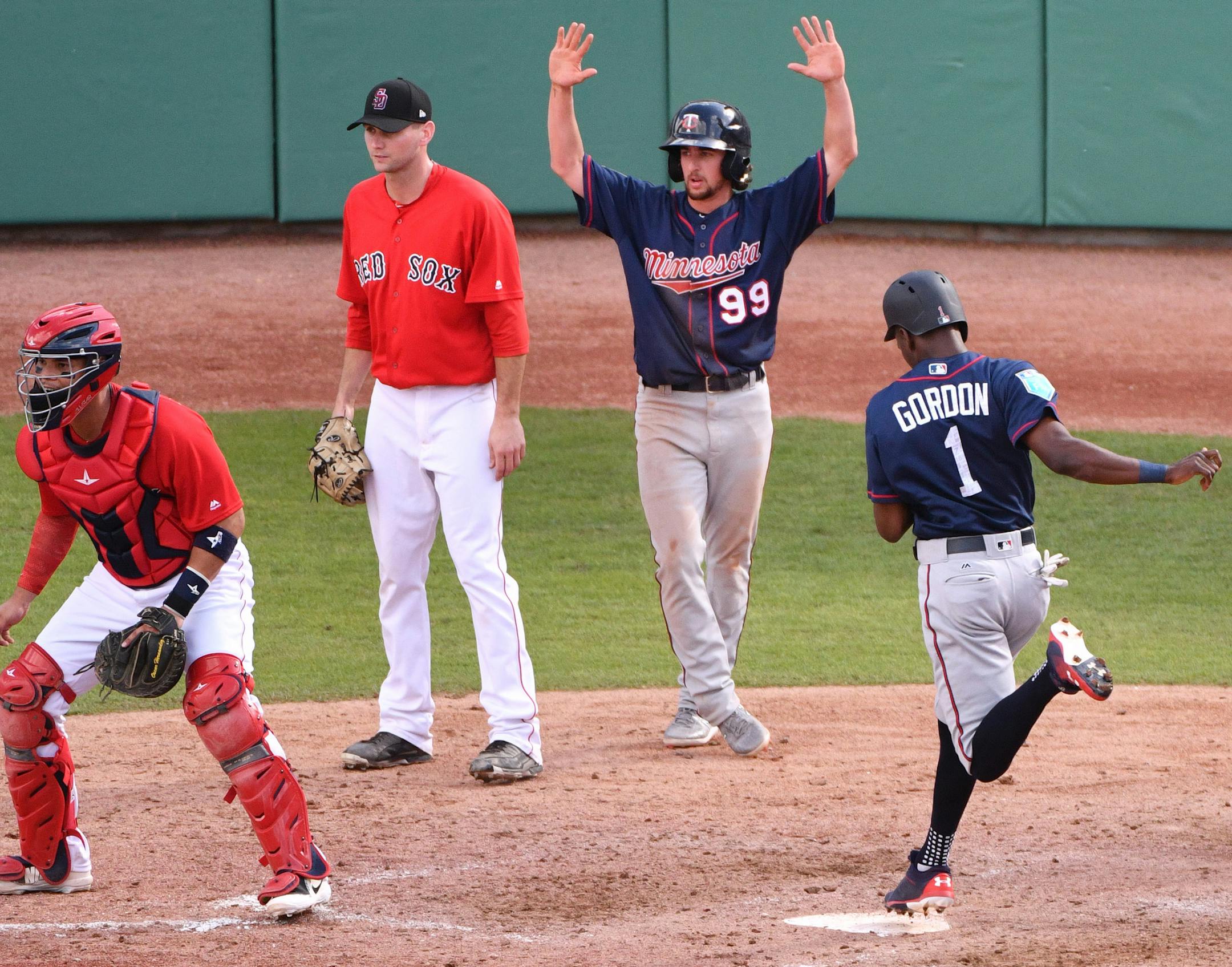 Twins infielder Nick Gordon (1) crossed home behind teammate Sean Miller (99) after single by Twins outfielder Ryan LaMarre (72). ] MARK VANCLEAVE ï mark.vancleave@startribune.com * The Minnesota Twins played the Boston Red Sox at JetBlue Park in Fort Myers, Florida on Friday, Feb. 23, 2018.