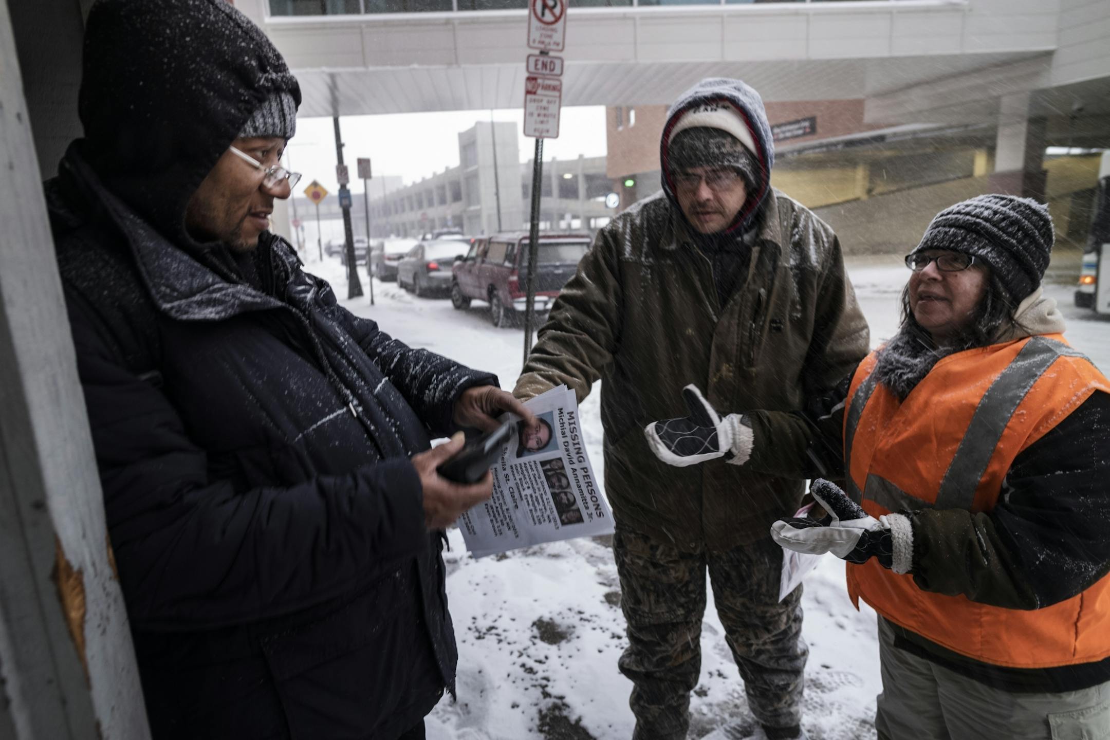Ronald Carter accepted a flier from Jason Goward and Toni Branley about missing persons. Carter said he would hang the flier at his Duluth apartment complex.