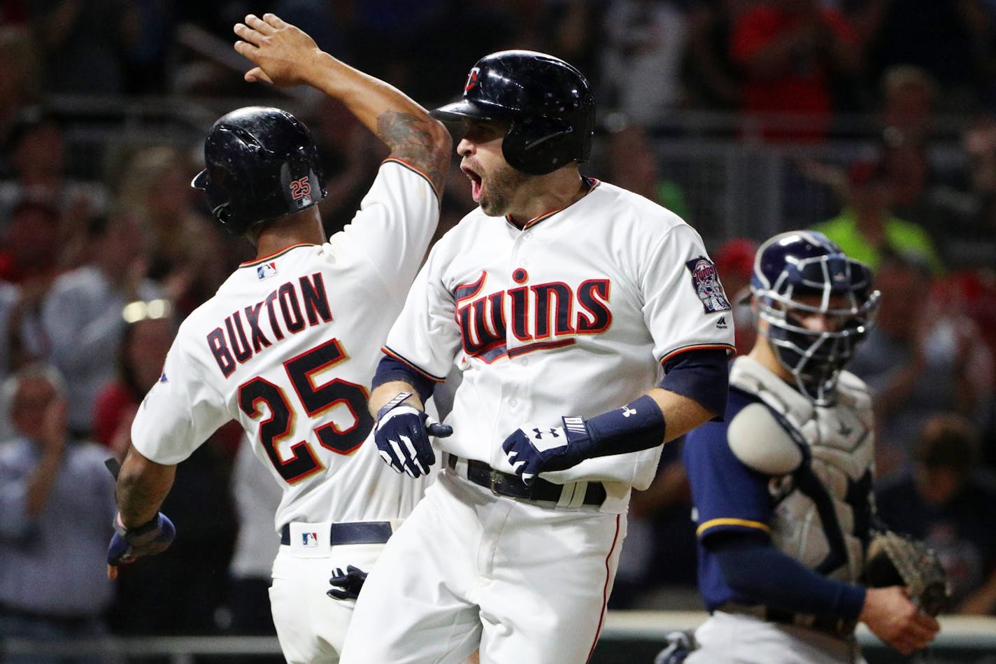 Minnesota Twins second baseman Brian Dozier (2) celebrated at home plate with Minnesota Twins center fielder Byron Buxton (25) after hitting a grand slam in the fourth inning.