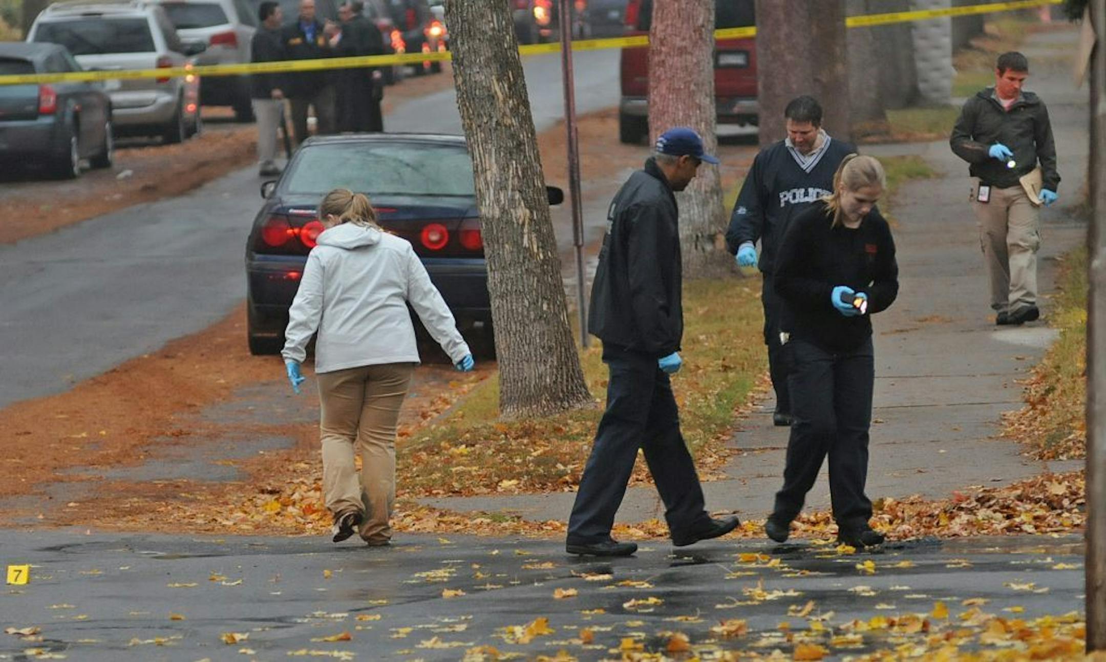 Police looked for evidence near where a man was shot to death early Tuesday in north Minneapolis. The body was found in the street near Sheridan and 8th Avenues at about 5 a.m., police said.
