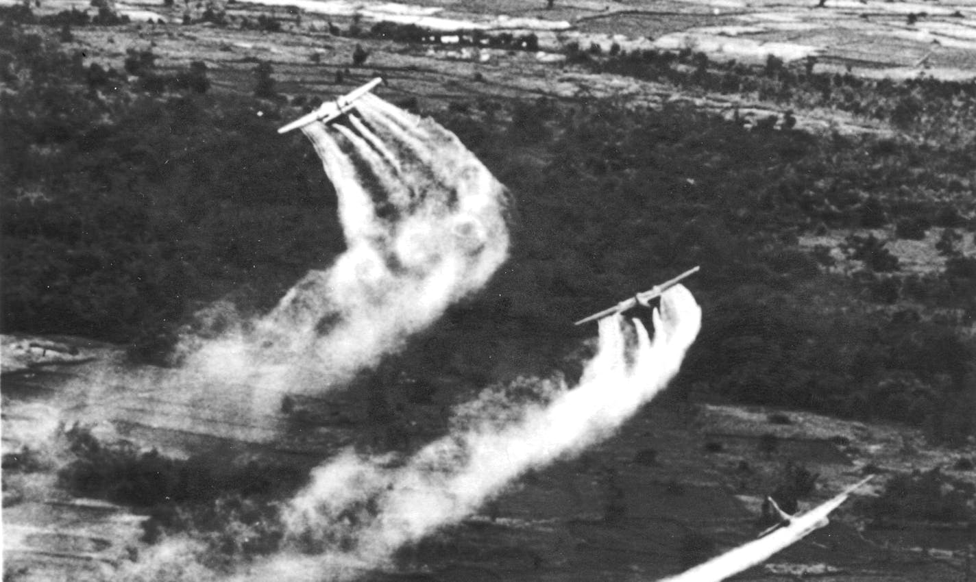 For use with VETS0506 U.S. Air Force planes spray the defoliant chemical Agent Orange over a jungle area in South Vietnam in 1966 as part of a program to seek out Viet Cong.