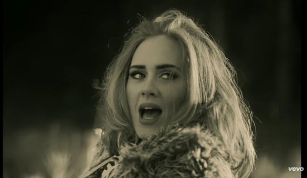 Adele performs in the new music video for her song "Hello."
