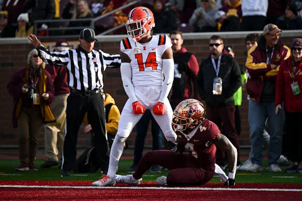 Illinois defensive back Xavier Scott (14) celebrated after breaking up a pass intended for the Gophers’ Corey Crooms Jr. in Saturday’s game at Hun