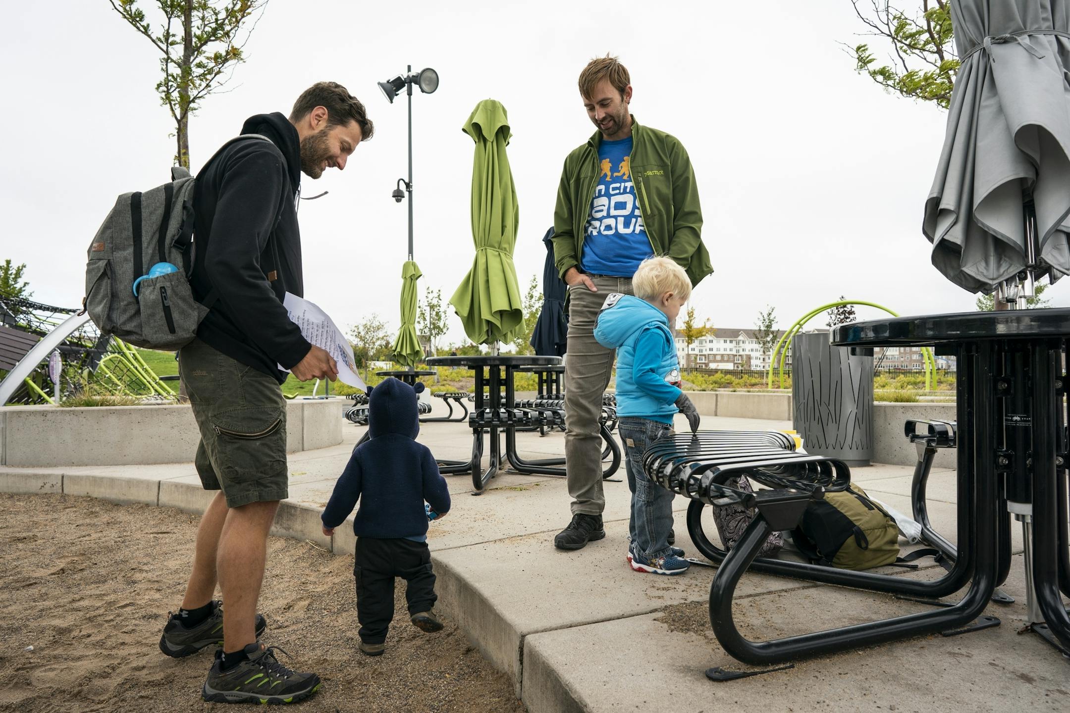 Keith Nagel, right, with his son Sawyer, 3, gives information about Twin Cities Dads to fellow stay-at-home dad John Mackenzie, left, whom he just met at Central Park.