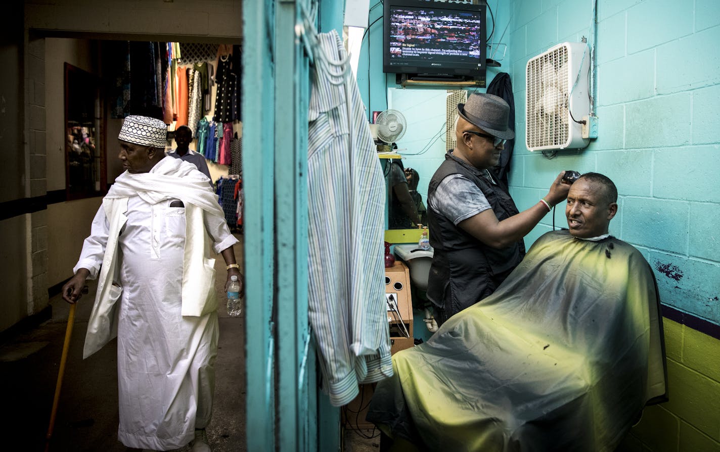 Mohamed Sheikh Mahamoud got his hair cut for Eid by barber JJ (that's the only name he would give) at the busy Village Market in Minneapolis, Minn., September 8, 2016. ] RENEE JONES SCHNEIDER &#x2022; renee.jones@startribune.com As Eid al-Adha and the 15th anniversary of the Sept. 11 fast approaches, Twin Cities Muslims are thinking about ways to strike a balance between these two major events and are also wary of heightened security.