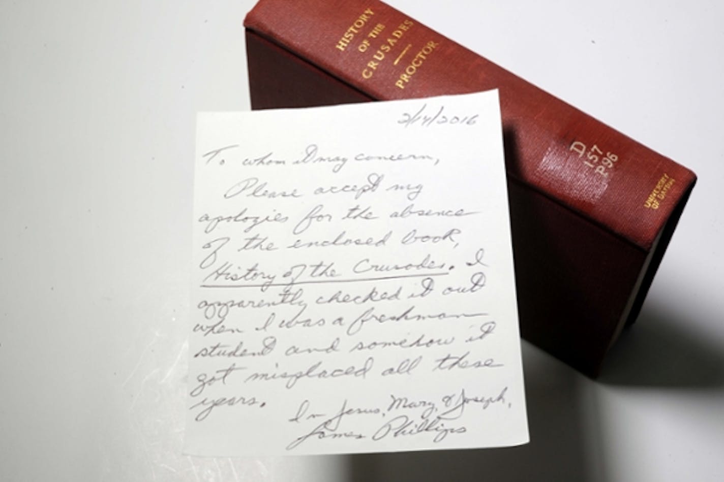 The book that James Phillips returned 49 years late to the University of Dayton, and his note of explanation.