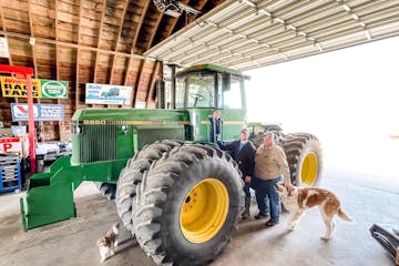 Outgoing Minnesota Farm Bureau President Kevin Paap with son Andy Paap and grandson Lennox Paap at their Blue Earth County farm.