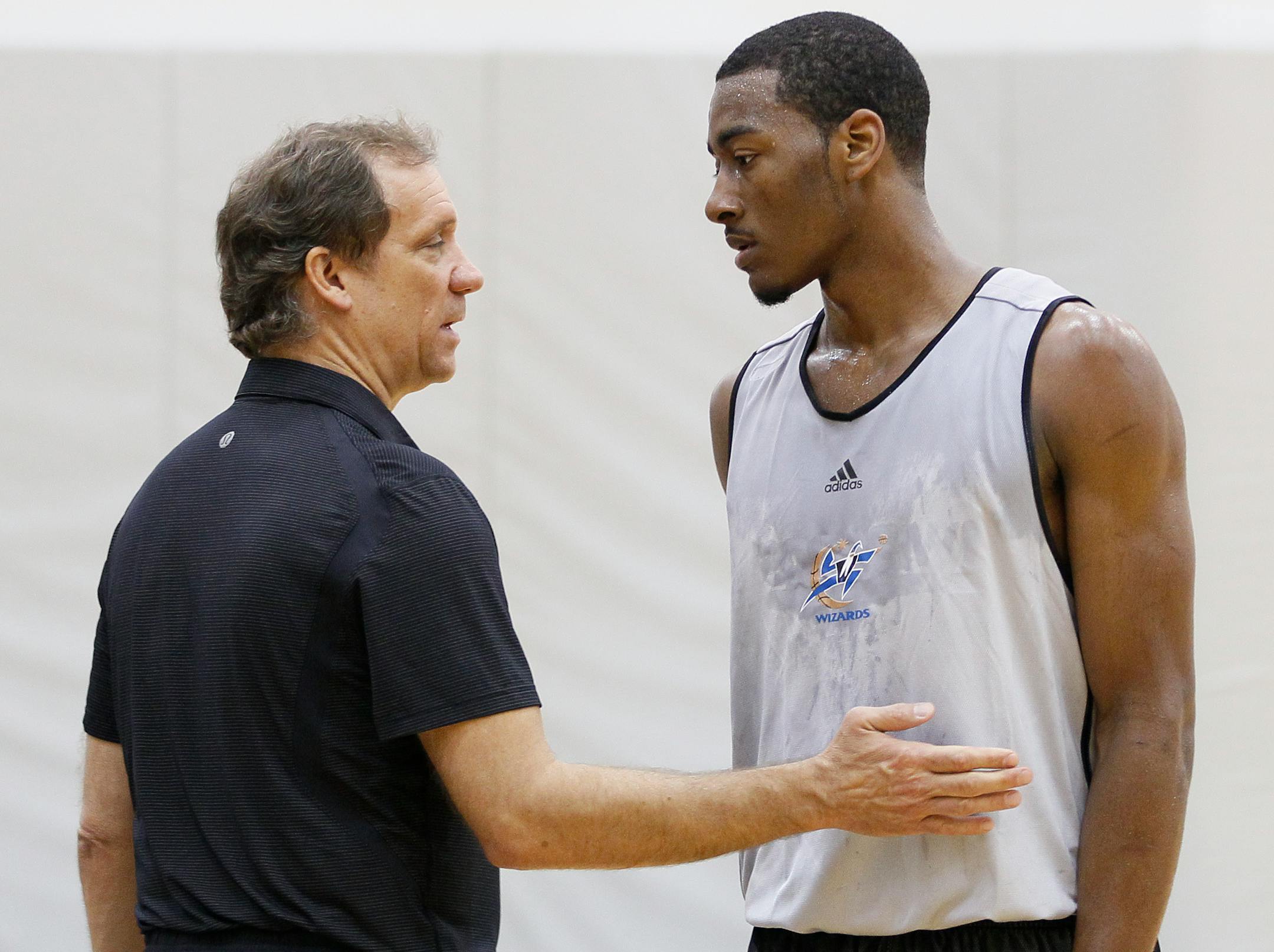 Washington Wizards basketball coach Flip Saunders, left, talks with Kentucky's John Wall during a pre-NBA draft basketball workout for the Washington Wizards, Thursday, June 17, 2010, in Washington. (AP Photo/Carolyn Kaster)