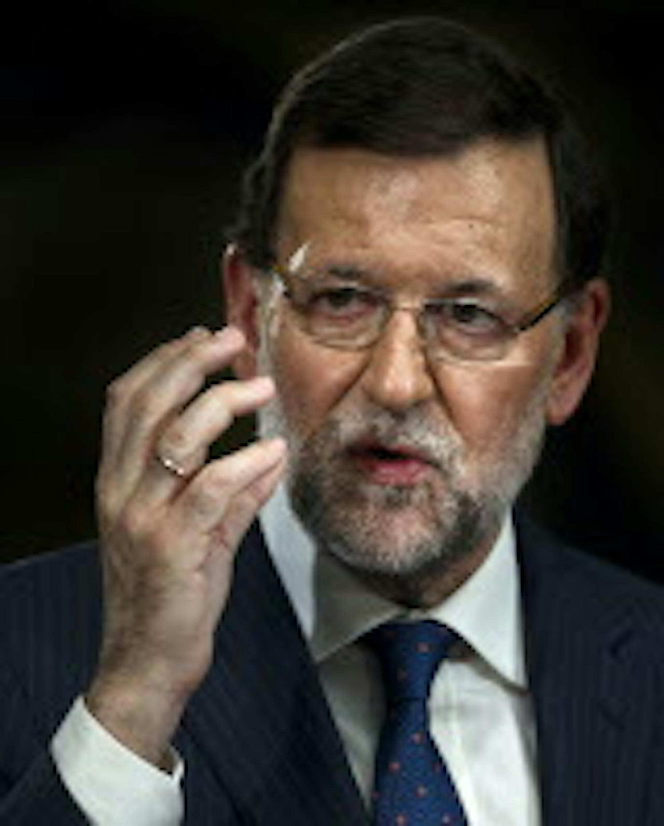 Spain's Prime Minister Mariano Rajoy gestures during a press conference at Moncloa palace in Madrid on Friday, Aug. 1, 2014. Rajoy said Spain's economy is recovering better than expected. Unemployment in Spain remains high at 24.5%. (AP Photo/Daniel Ochoa de Olza) †