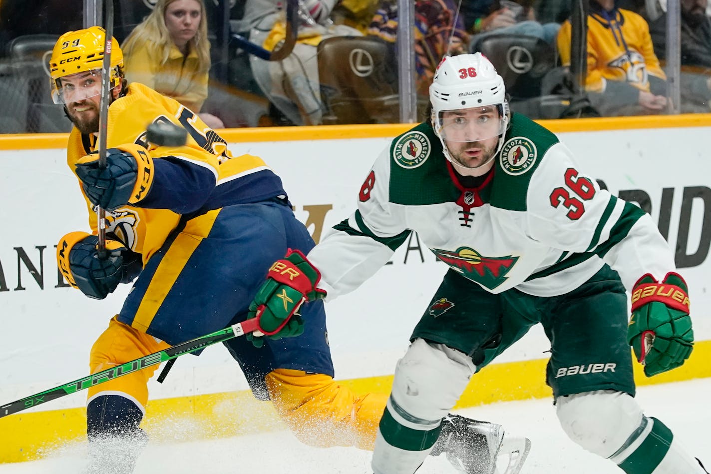 Nashville Predators' Roman Josi (59) passes the puck away from Minnesota Wild's Mats Zuccarello (36) in the third period of an NHL hockey game Tuesday, April 5, 2022, in Nashville, Tenn. (AP Photo/Mark Humphrey)