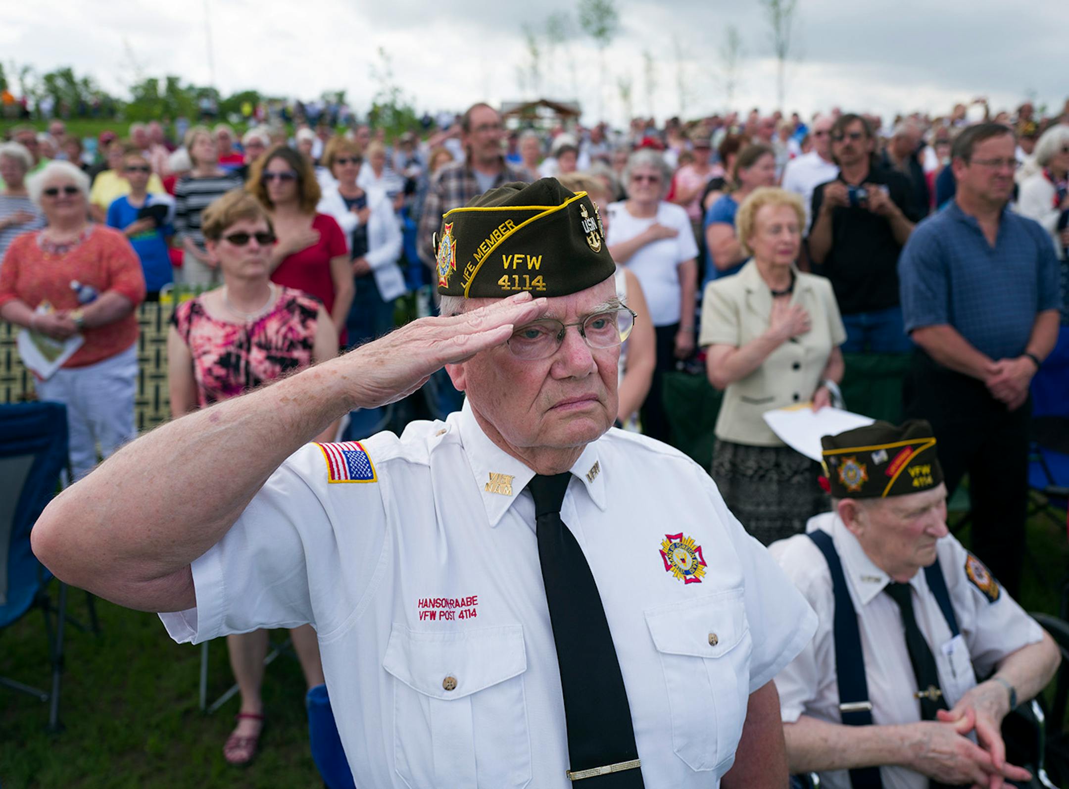 Minnesota Navy veteran Roger Tangen saluted as the flags were posted at the Minnesota State Veterans Cemetery Sunday, May 29, 2016, in Preston, MN.