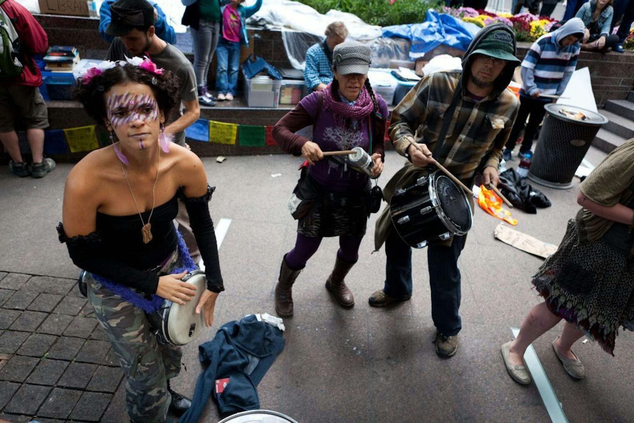 Occupy Wall Street protestors play drums and sing songs in the financial district's Zuccotti park Sunday, Oct. 2, 2011, in New York. The protests have gathered momentum and gained participants in recent days as news of mass arrests and a coordinated media campaign by the protestors have given rise to similar demonstrations around the country.
