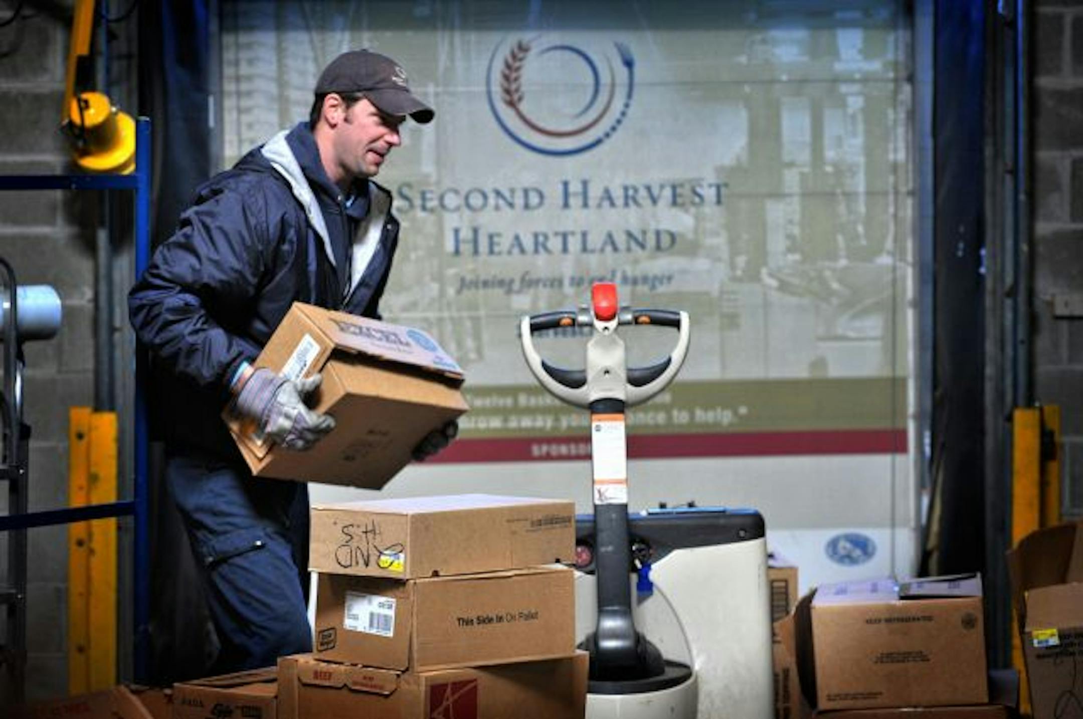 Jason Van Den Boom, driver for Second Harvest Heartland, loaded fresh food donated by the Shakopee Wal-Mart.