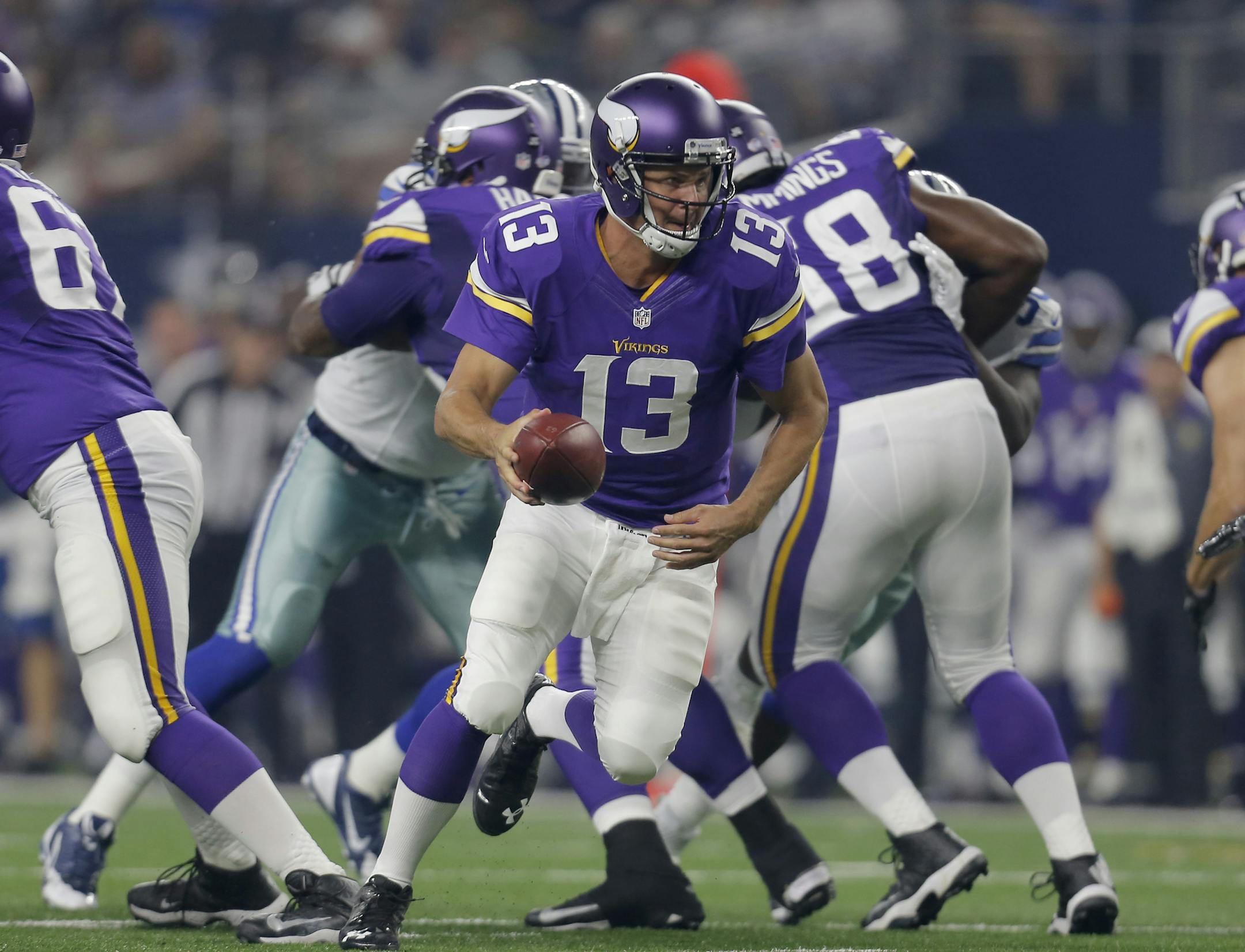 Minnesota Vikings quarterback Shaun Hill (13) rolls out with the ball against the Dallas Cowboys during the first half of a preseason NFL football game Saturday, Aug. 29, 2015, in Arlington, Texas. (AP Photo/Brandon Wade)