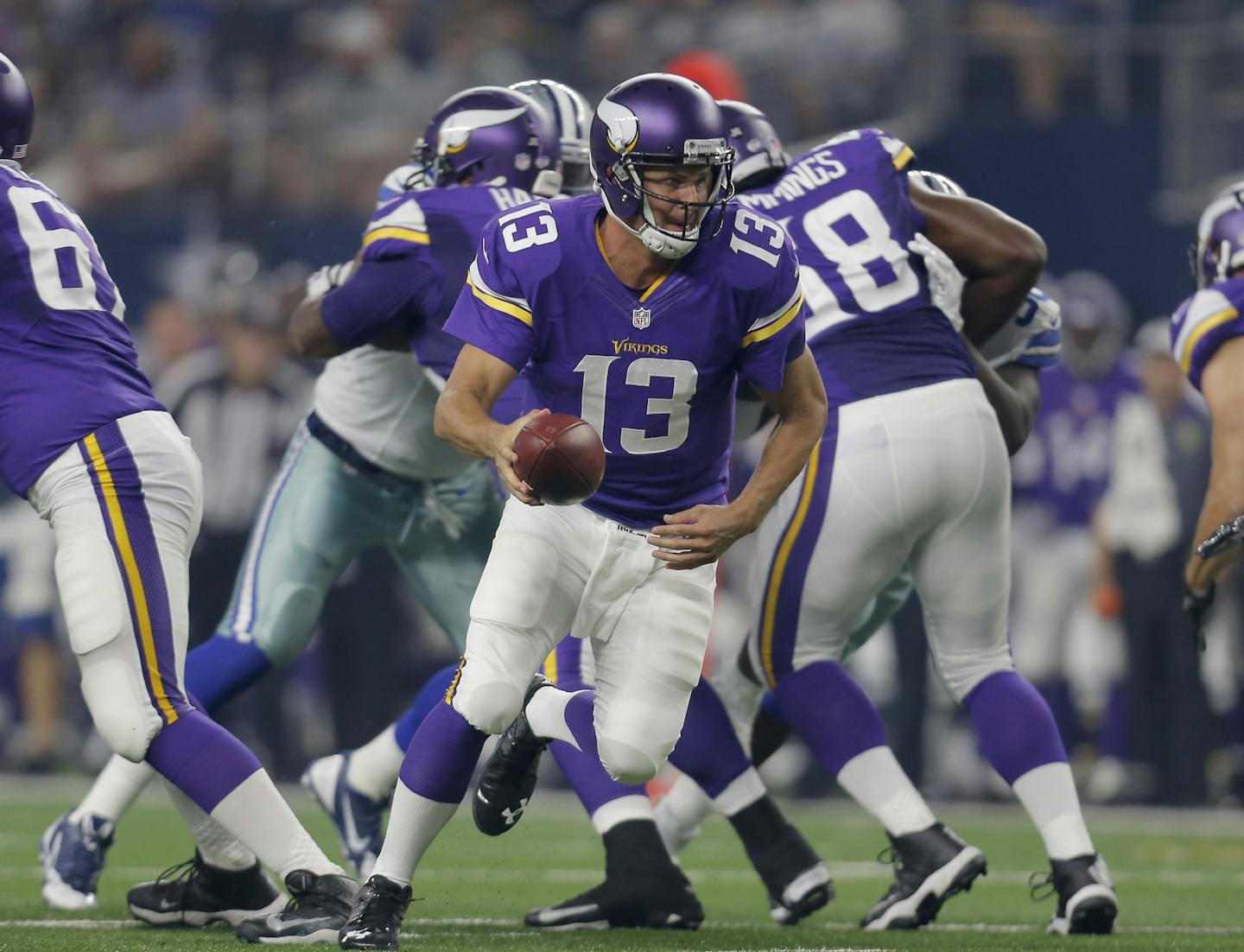 Minnesota Vikings quarterback Shaun Hill (13) rolls out with the ball against the Dallas Cowboys during the first half of a preseason NFL football game Saturday, Aug. 29, 2015, in Arlington, Texas. (AP Photo/Brandon Wade)