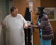 This image released by CBS shows Billy Gardell as Bob, left, and Folake Olowofoyeku as Abishola in a scene from "Bob Hearts Abishola," a comedy about 