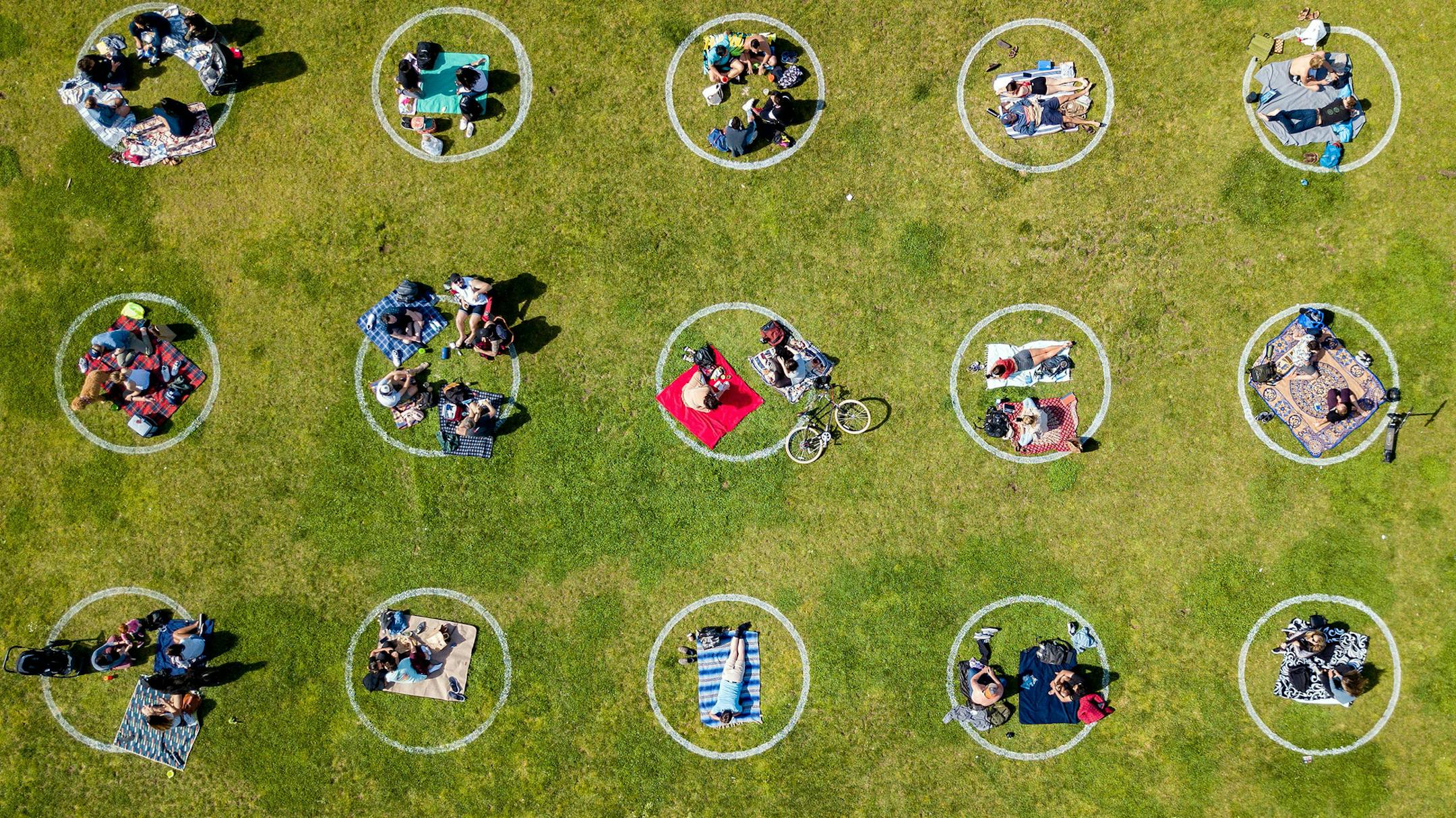 An aerial view shows people gathered inside painted circles on the grass encouraging social distancing at Dolores Park in San Francisco, California on May 22, 2020 amid the novel coronavirus pandemic. (Josh Edelson/AFP/Getty Images/TNS) ORG XMIT: 1725671