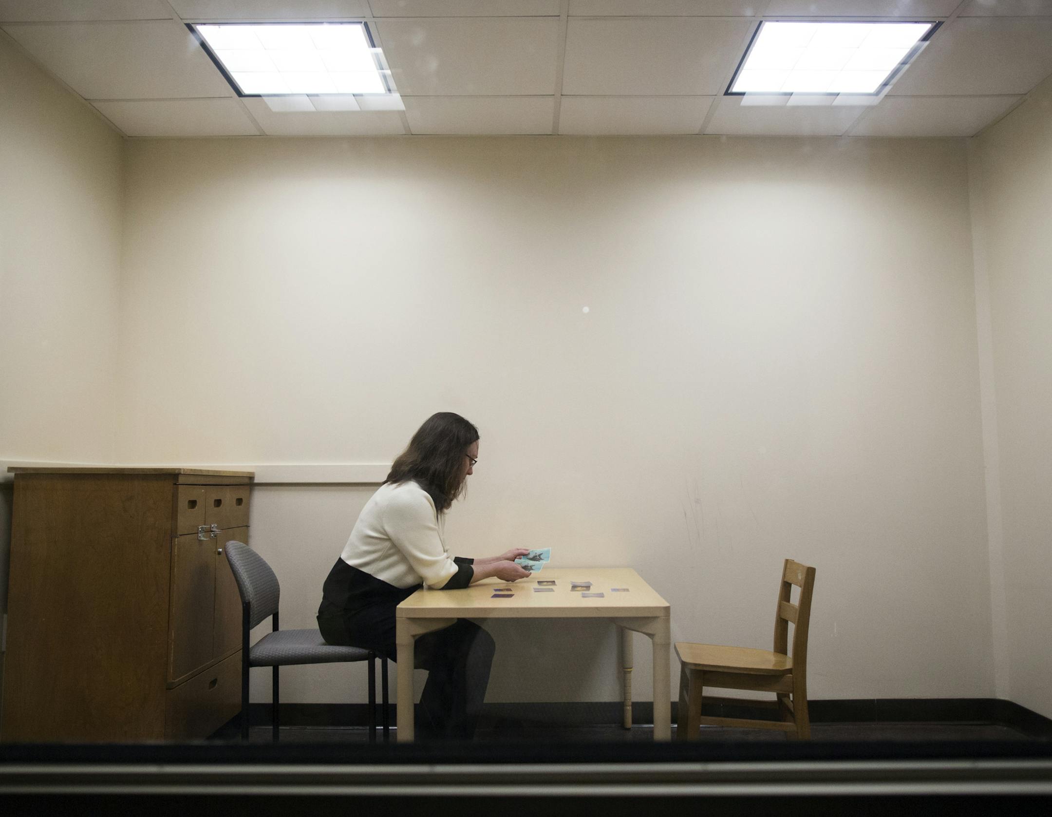 Pamela Ventola, an assistant professor at Yale, holds cards used during pivotal response treatment at the university's child study center in New Haven, Ct., April 3, 2014. Ventola is among a group of scientists who are proposing to study the treatment, which targets areas of a child's interests and incorporates animated characters as a way to achieve a deeper connection among its patients. (Christopher Capozziello/The New York Times) ORG XMIT: XNYT35