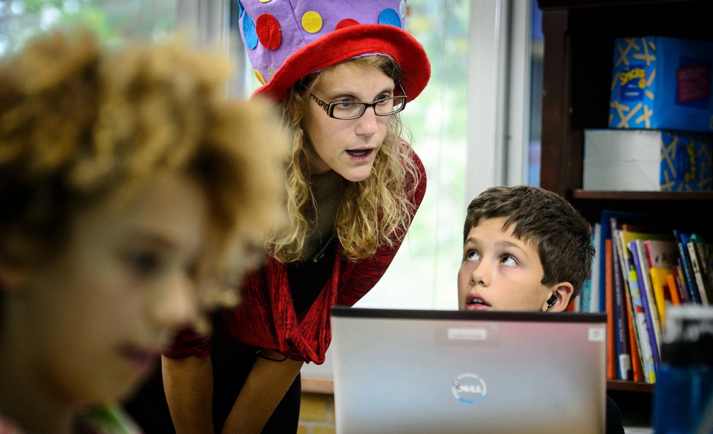 At Deephaven Elementary School Spanish fourth grade emersion teacher Kirsten Lunzer worked with William Sadowski on a coding problem. She wears a polkadot hat when speaking in English and the hat comes off when she speaks Spanish. ] Thursday, September 25, 2014