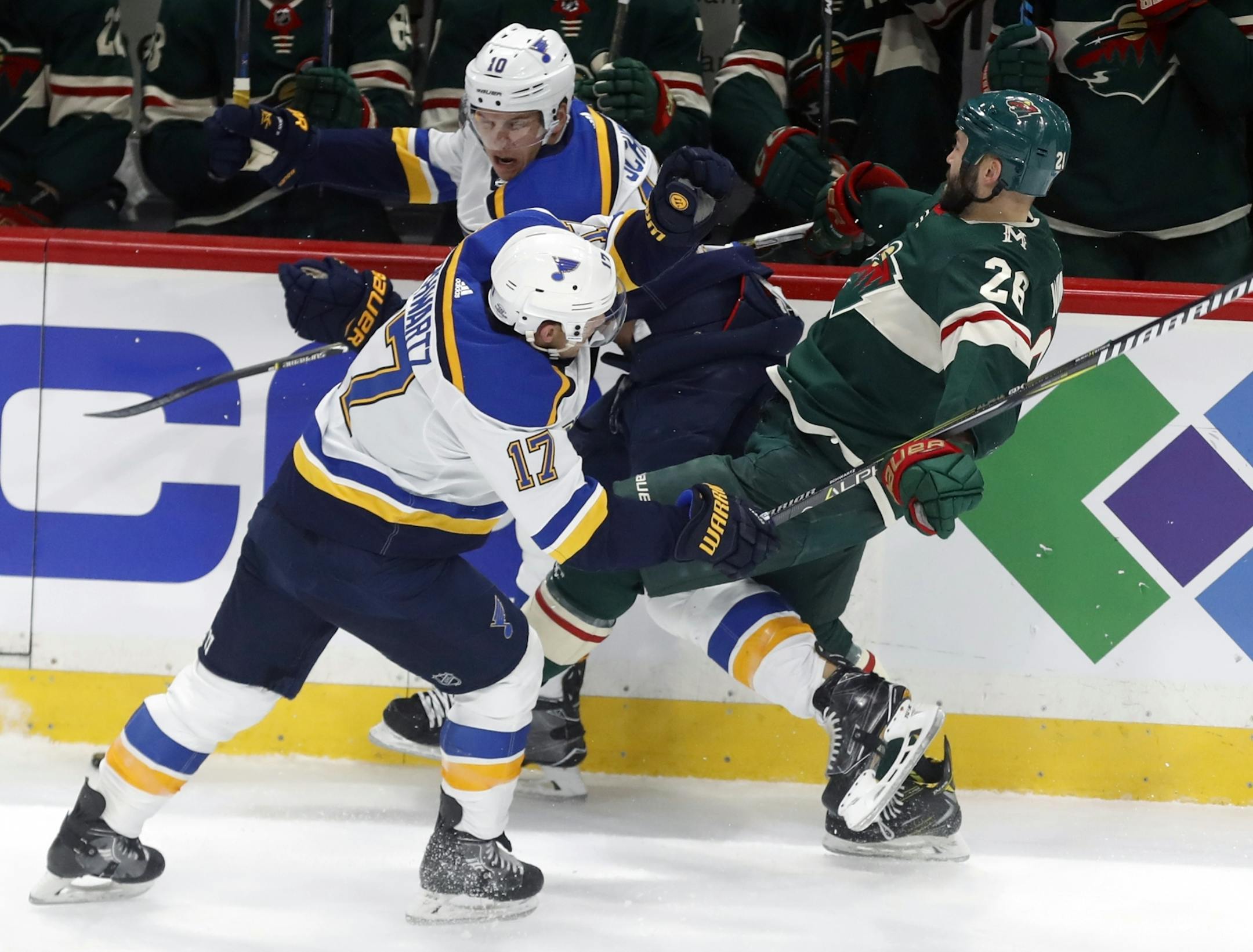 Jade Schwartz(17) and Brayden Schenn(10) of the Blues get tangled up with Daniel Winnik(26).
