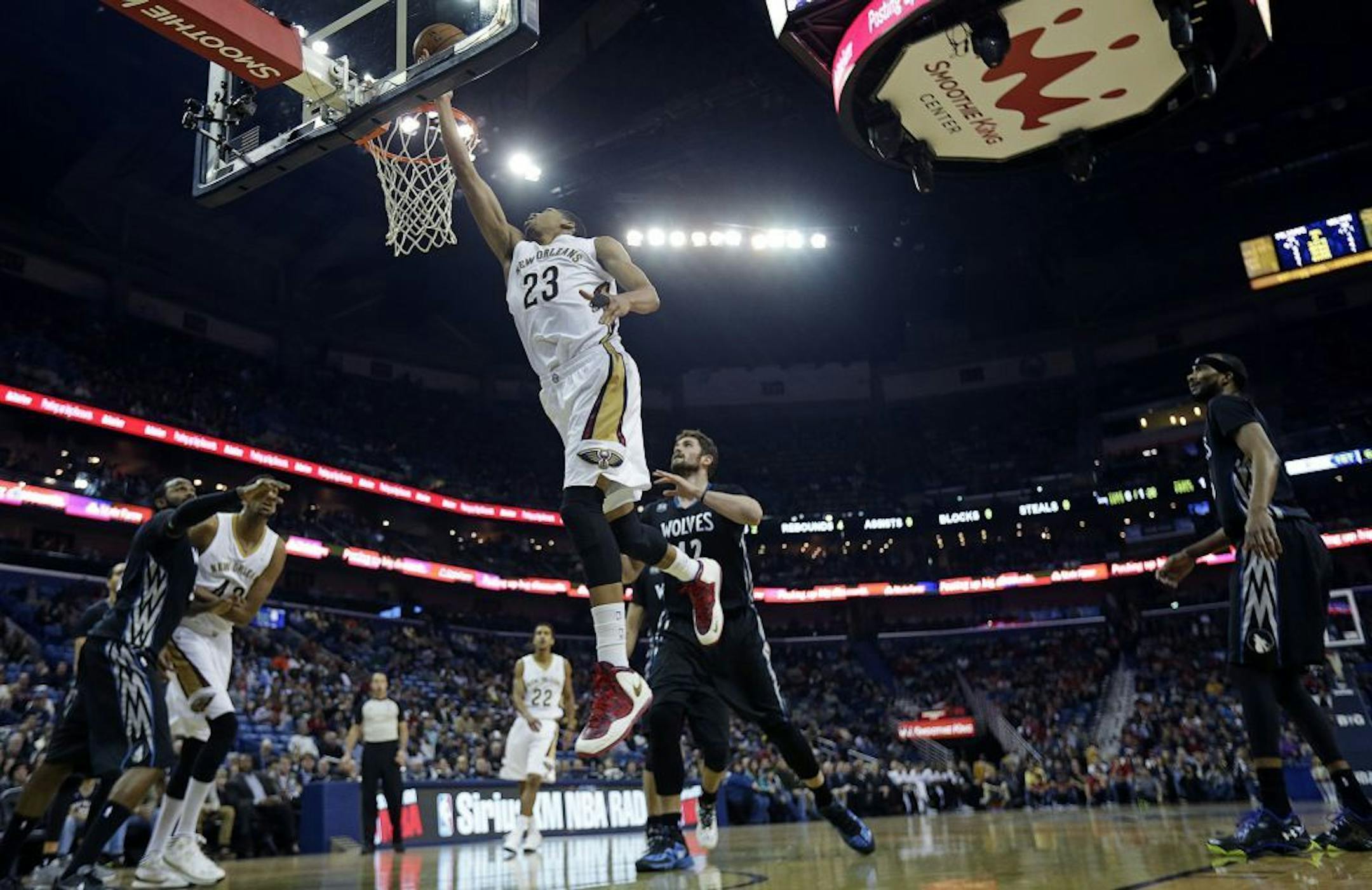 New Orleans Pelicans power forward Anthony Davis (23) goes to the basket in front of Minnesota Timberwolves power forward Kevin Love (42) in the first half of an NBA basketball game in New Orleans, Friday, Feb. 7, 2014.