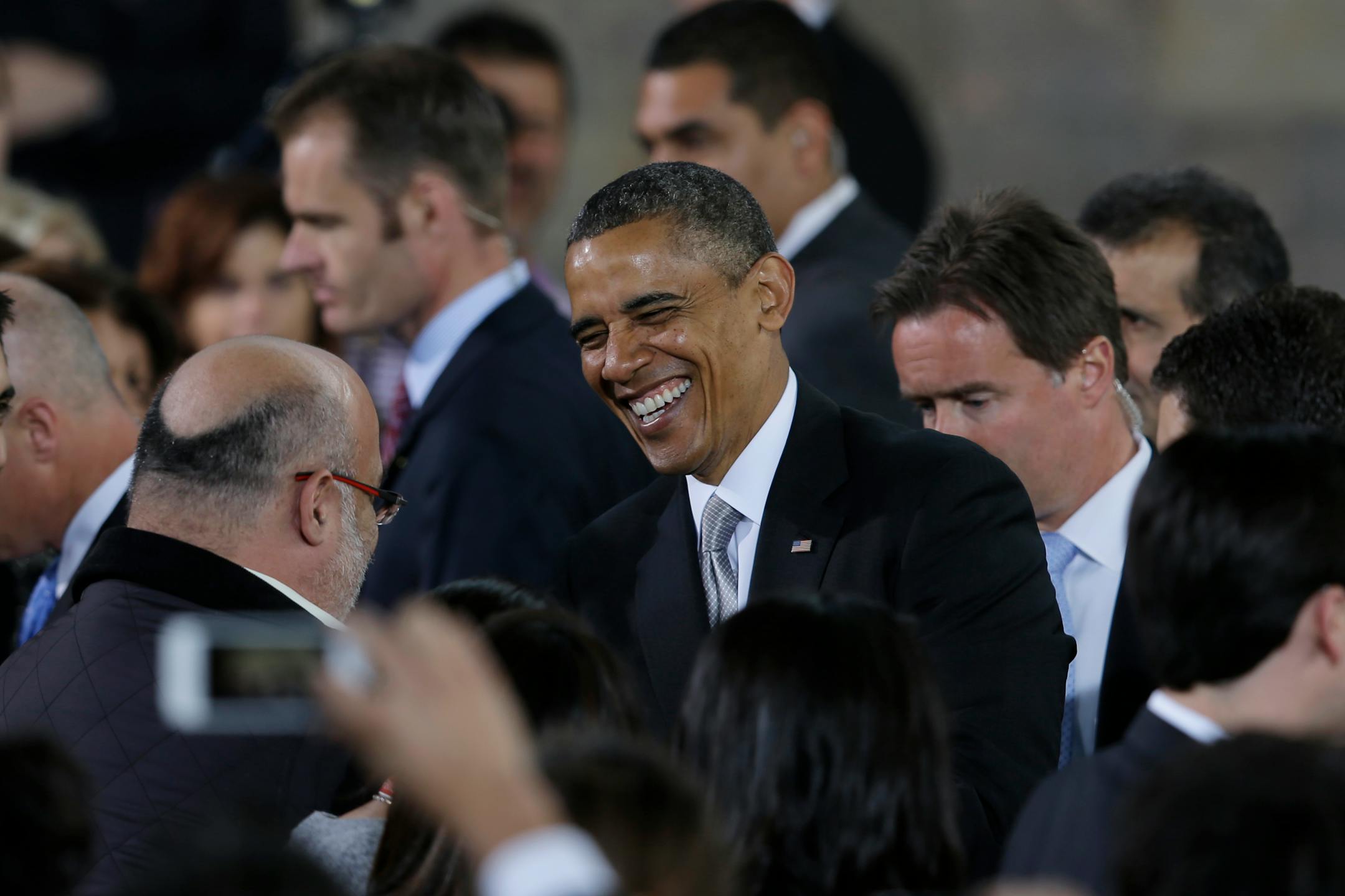 President Barack Obama laughs as he greets people in the audience after speaking at the Anthropology Museum in Mexico City, Mexico, Friday, May 3, 2013. Obama spoke on the second day of his Mexico City visit, peppering his remarks with Spanish phrases, including that he was "entre amigos" or "among friends." He concluded with "Viva Mexico. Viva los Estados Unidos. Que Dios los bendiga" or "Long live Mexico. Long live the United States. May God bless them." (AP Photo/Dario Lopez-Mills)