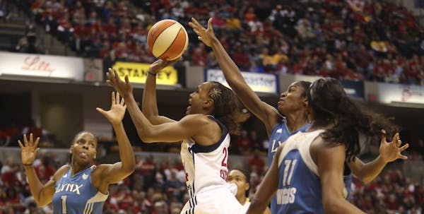 Indiana Fever�s Tamika Catchings, #24, goes for the shot amidst the Minnesota Lynx defense during game 3 of the WNBA Finals at Bankers Life Fieldhou