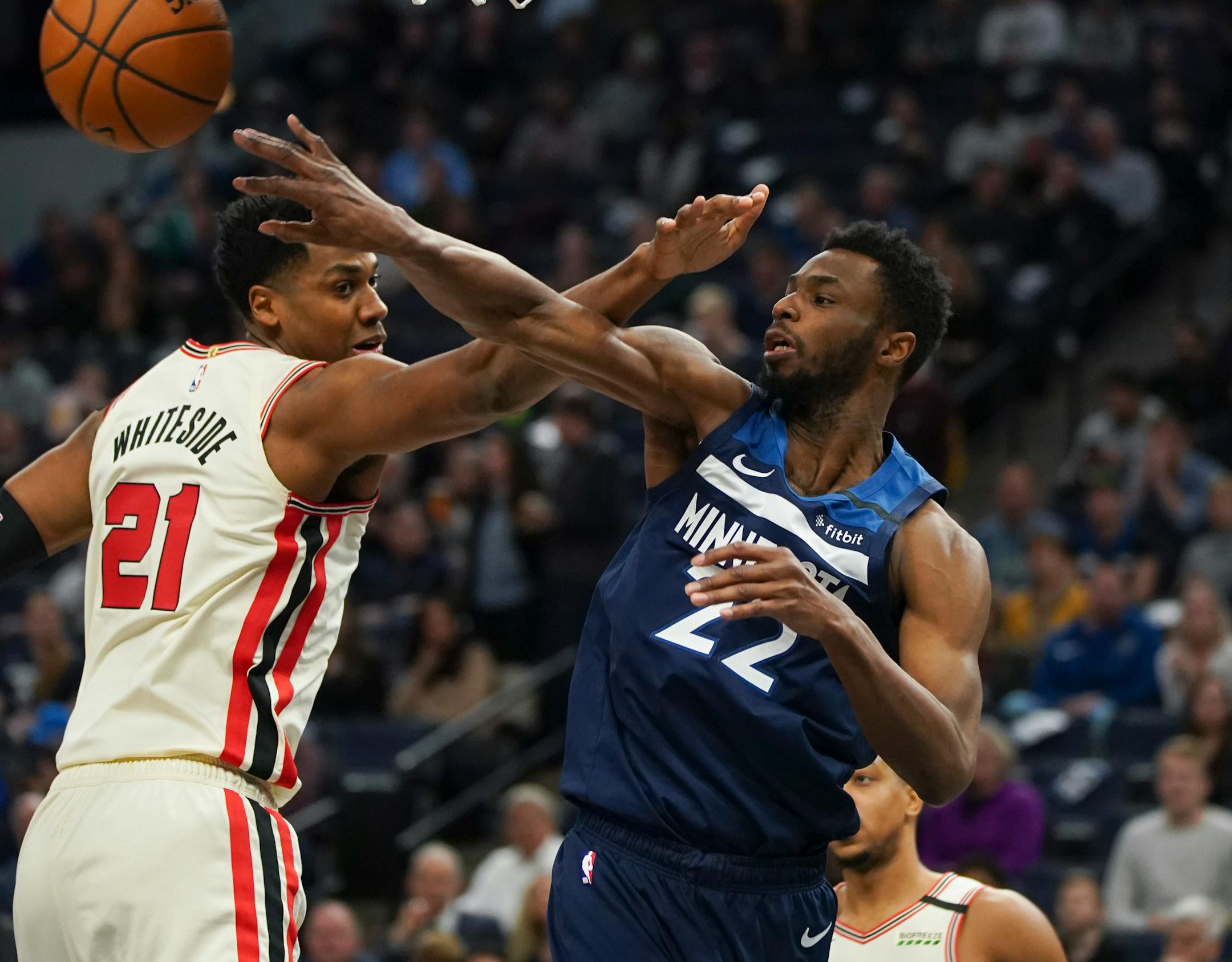 Timberwolves forward Andrew Wiggins passed off to a teammate around Trail Blazers center Hassan Whiteside in the second quarter.