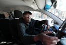 Uber driver Mohamed Egal accepts a rider on the app on Feb. 16 in Minneapolis.