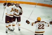 Bryce Brodzinski (22) celebrated with teammates after they defeated Michigan State on Sunday at 3M Arena at Mariucci.
