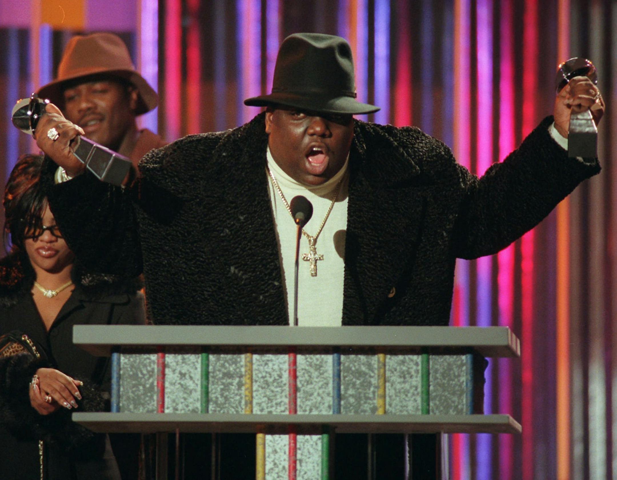 FILE - In this Dec. 6, 1995, file photo, rapper Notorious B.I.G., who won rap artist and rap single of the year, clutches his awards at the podium during the annual Billboard Music Awards in New York. Voletta Wallace details the love for the Notorious B.I.G. as both his mother and No. 1 fan in the new, three-hour documentary, ìBiggie: The Life of Notorious B.I.G.î It debuts Monday, Sept. 4, 2017, at 8 p.m. EST on A&E. (AP Photo/Mark Lennihan, File)
