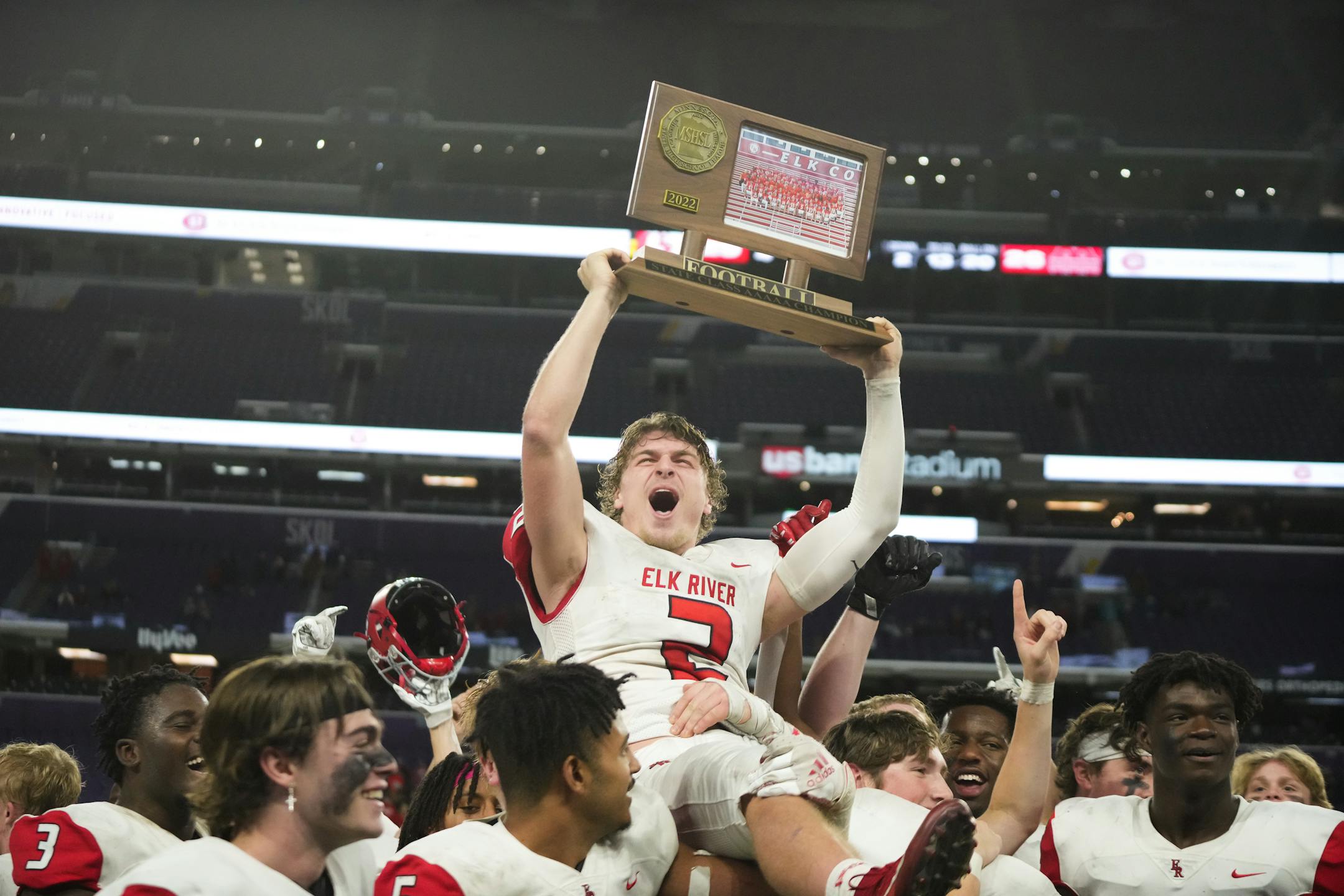 The Elk River players held up quarterback Cade Osterman (2) after defeating Mankato West in the Minnesota High School football Class 5A State Championship at U.S. Bank Stadium in Minneapolis, Minn., on Saturday, Dec. 3, 2022.