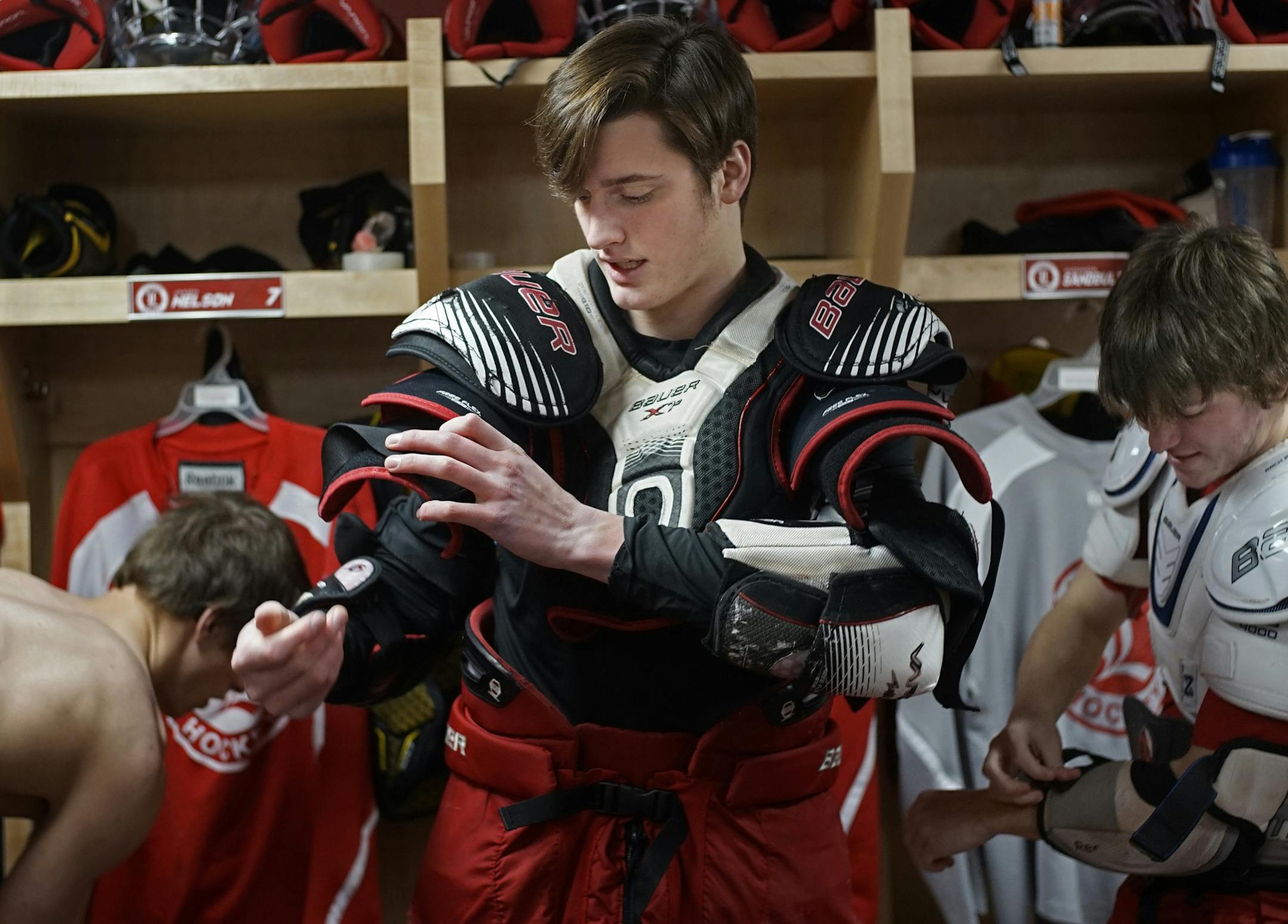 At the Blue Mound Ice Arena, the Luverne hockey team has built a strong following and culture in the region. (F) Chaz Smedsrud puts on his equipment with (D) Connor Sandbulte on the right.] rtsong-taatarii@startribune.com/ Richard Tsong-Taatarii