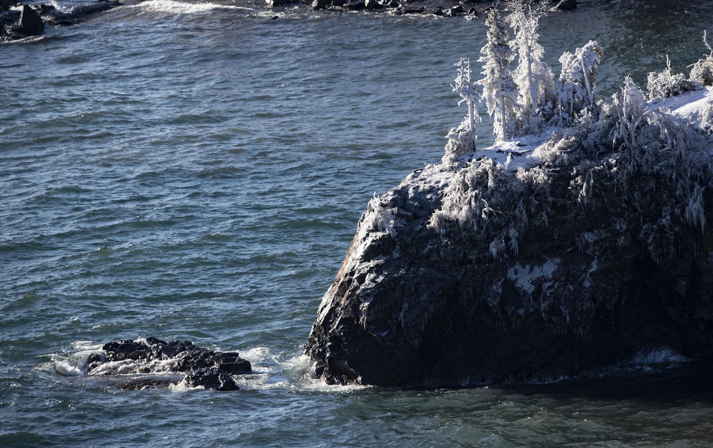 The collapsed sea stack lay in Lake Superior with small waves crashing on it. The Minnesota landmark collapsed during the intense storm over the weekend.