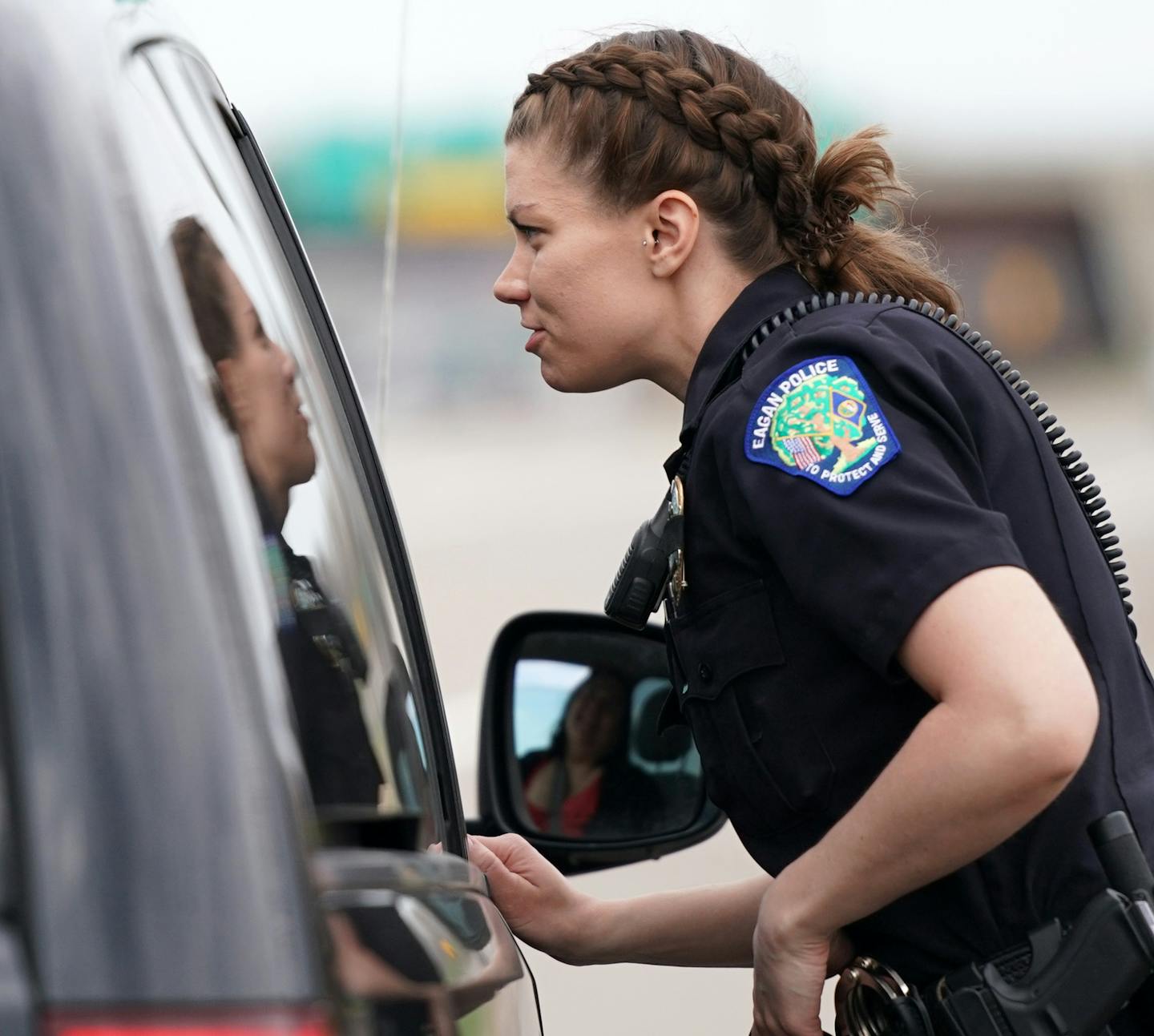 Eagan officer Kirsten Dorumsgaard talked with a motorist who was ticketed for typing on their phone while driving during Wednesday's "Busted by the Bus" initiative. ] ANTHONY SOUFFLE • anthony.souffle@startribune.com Police rode a school bus looking for distracted drivers using their cell phones as part of an initiative called "Busted by the Bus" Wednesday, April 24, 2019 in Egan, Minn. Once a distracted driver was spotted the officers on the bus radioed to fellow police in squad cars who made t