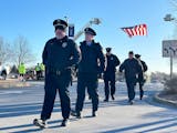 Just after 8 am, contingents from police departments across the state began arriving at Grace Church for a memorial service for Burnsville police offi