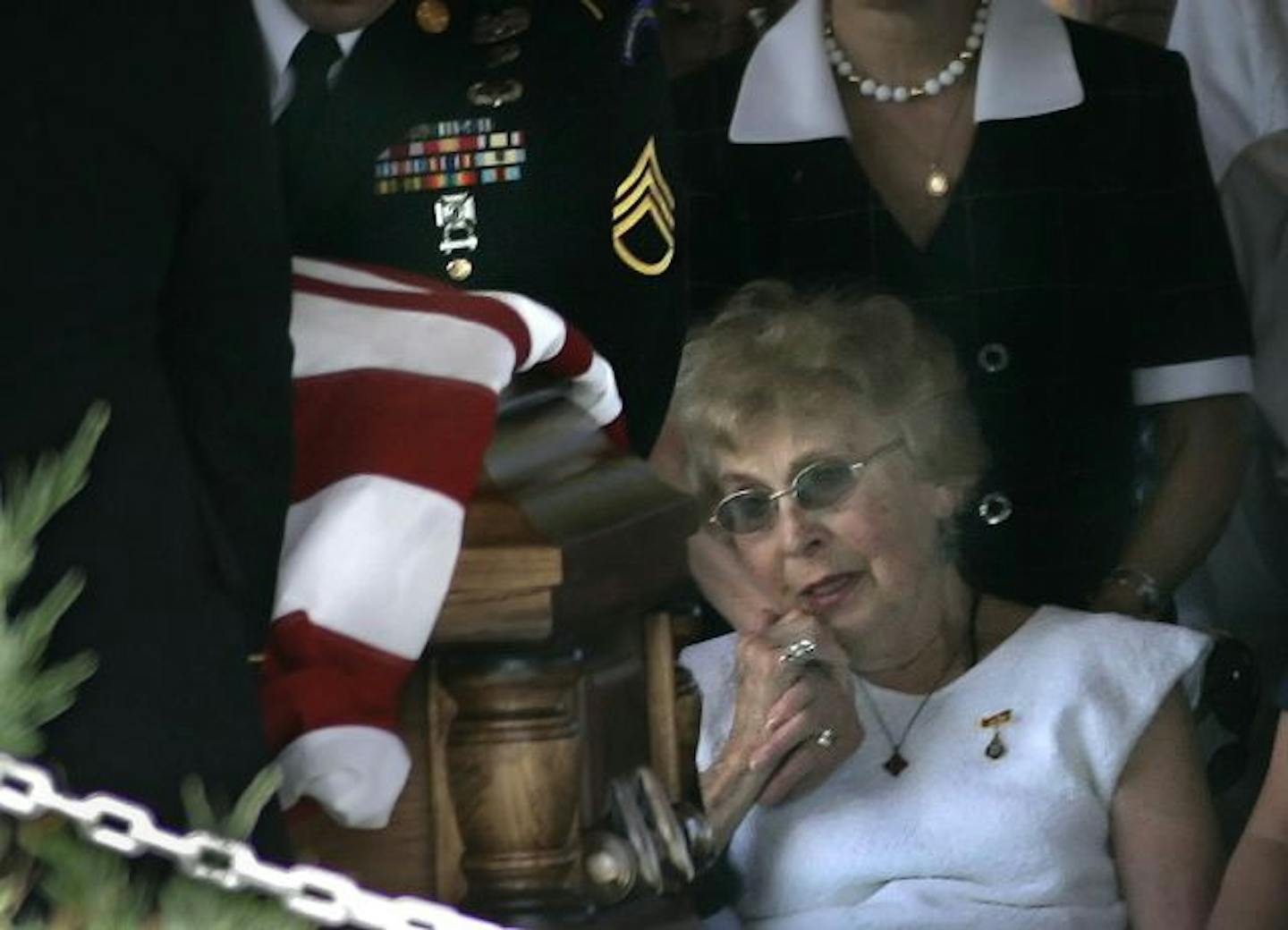 Phyllis Vakoc was comforted as military pallbearers at a burial service carried the flag-draped casket of her son, Father Timothy Vakoc at Fort Snelling National Cemetery. Vakoc was the Twin Cities priest who was severely injured in Iraq in 2004.