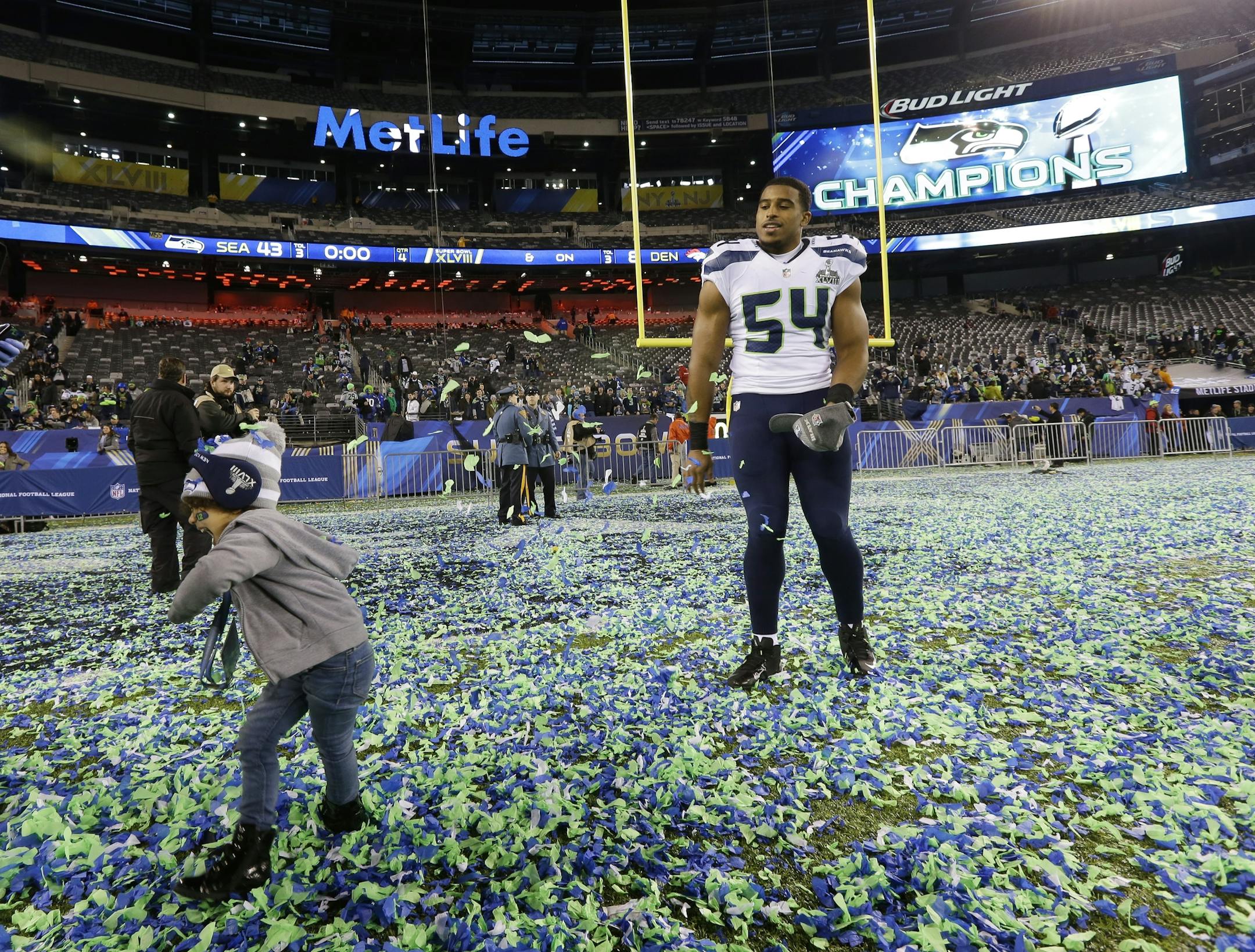 Seattle Seahawks' Bobby Wagner (54) celebrates with his daughter Quinncy, left, after the NFL Super Bowl XLVIII football game against the Denver Broncos Sunday, Feb. 2, 2014, in East Rutherford, N.J. The Seahawks won 43-8. (AP Photo/Ted S. Warren)