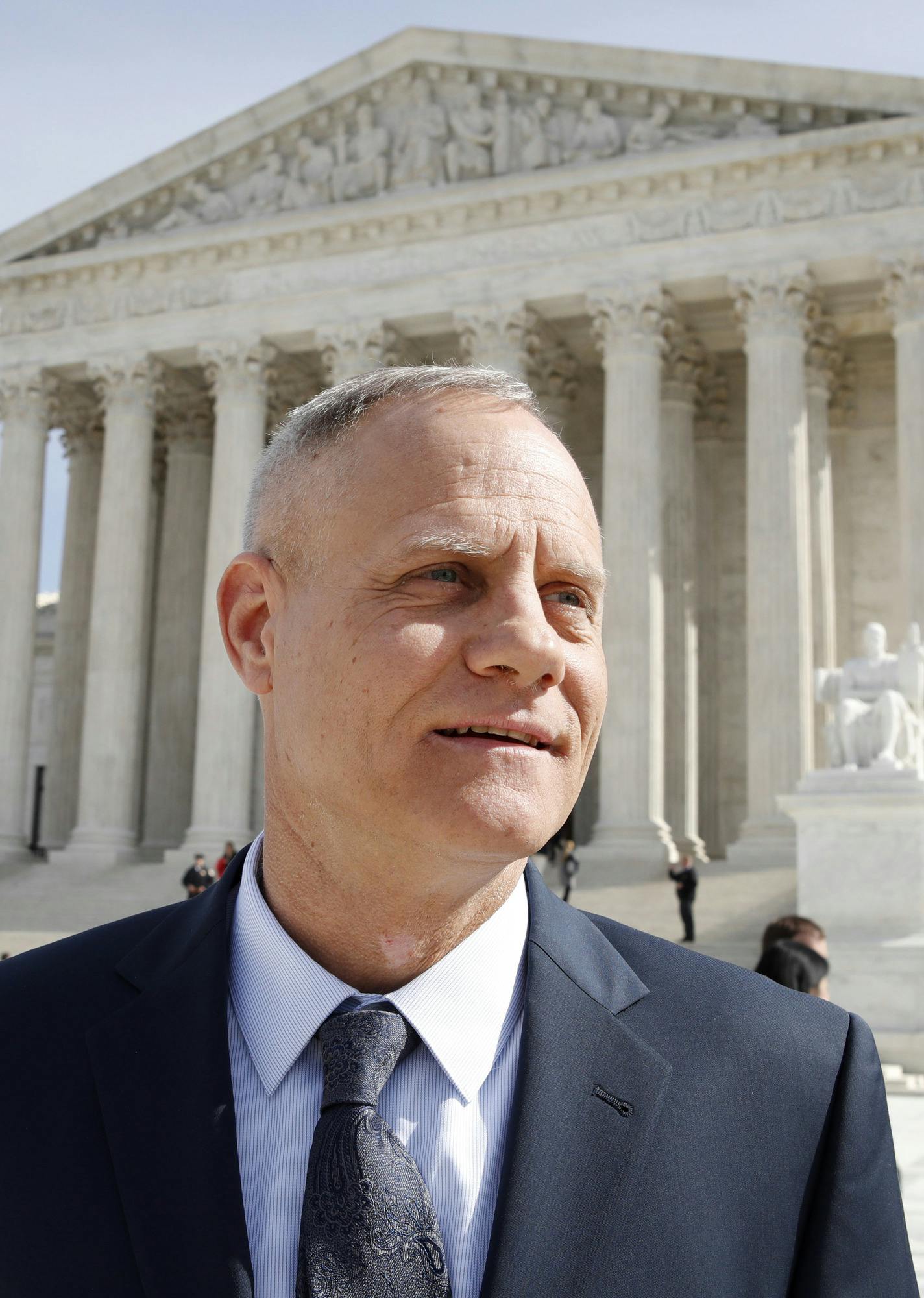 Andy Cilek stands outside of the Supreme Court, Wednesday, Feb. 28, 2018, in Washington, where a Minnesota law that bars residents from wearing political clothing at the polls &#x2014; from Donald Trump's "Make America Great Again" hats to Democratic Party T-shirts and union buttons &#x2014; is being debated at the Supreme Court. (AP Photo/Jacquelyn Martin)