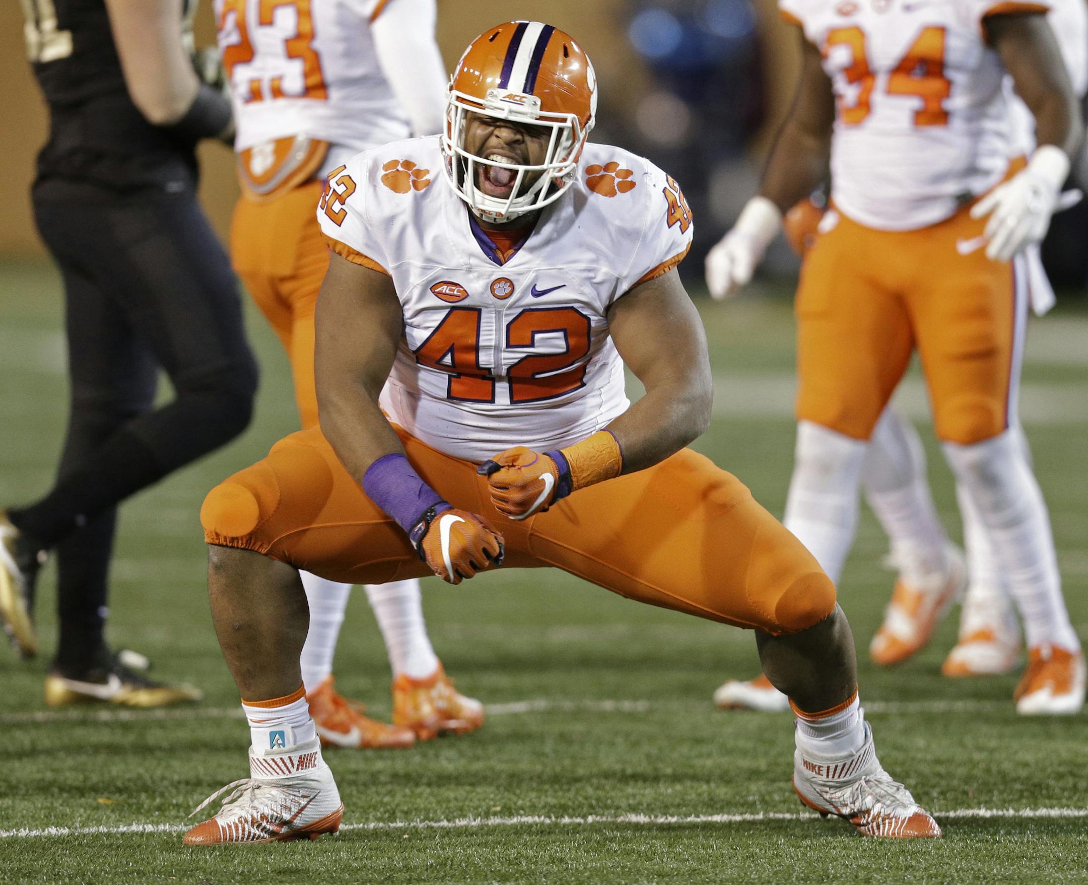 File-This Nov. 19, 2016, file photo shows Clemson's Christian Wilkins (42) celebrating after a play against Wake Forest during the first half of an NCAA college football game in Winston-Salem, N.C. Wilkins was named to the second team AP Preseason All-America Team on Tuesday, Aug. 22, 2017. (AP Photo/Chuck Burton, File) ORG XMIT: MIN2017082520253396