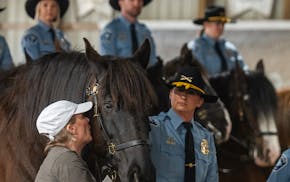 Carrie Brummer gave a little kiss to Teak, who is coming home to retire with her in Maple Plain, Minn.