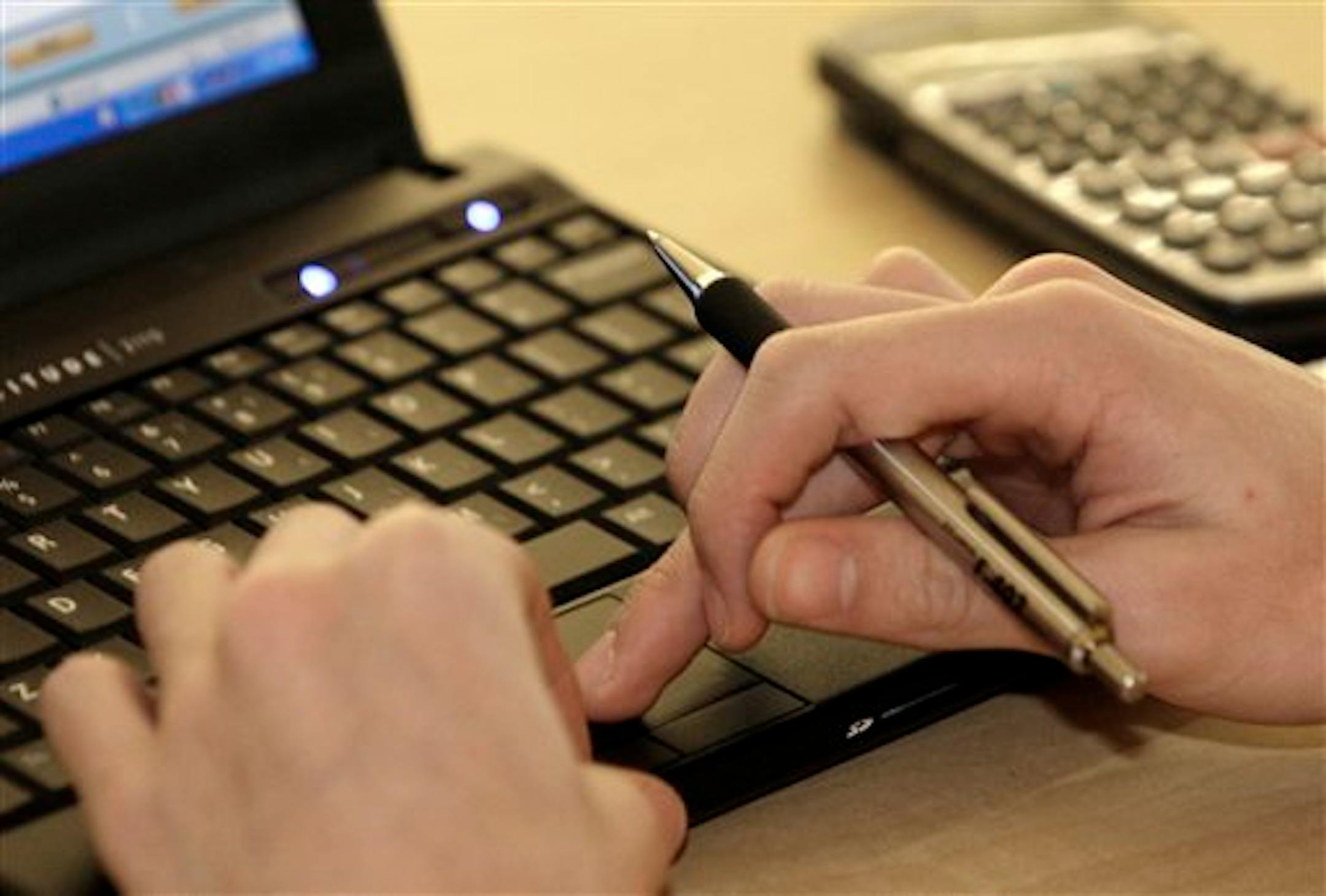 In this Feb. 1, 2012, photo, a student works with a computer and a calculator during a pilot math class at Reynoldsburg High School in Reynoldsburg, Ohio. More than four in 10 Ohio high school graduates get to college needing at least one remedial reading, science or math course. The makeup work is something they must complete, and pay for, before they begin earning credit toward their degree. Reynoldsburg High School offers a computer-based pilot course that's helping kids bridge the gap. (AP P