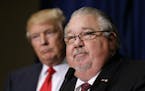 FILE - In this Aug. 25, 2016, file photo, Sam Clovis speaks during a news conference as then-Republican presidential candidate Donald Trump, left, wat