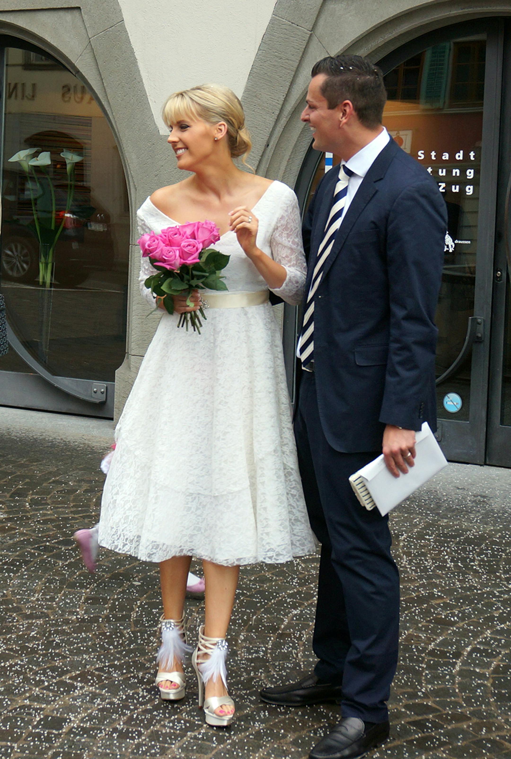 This May 3, 2013 photo released by Dale Janee Schroeter shows her wearing a vintage dress on her wedding day with husband Jakob Schroeter in Zug, Switzerland. The short looks aren't just stand-in dresses originally intended for bridesmaids or cocktail parties. Designers are offering a greater range of shorter styles as more brides break from tradition and personalize their weddings. (AP Photo/www.savvyspice.com)