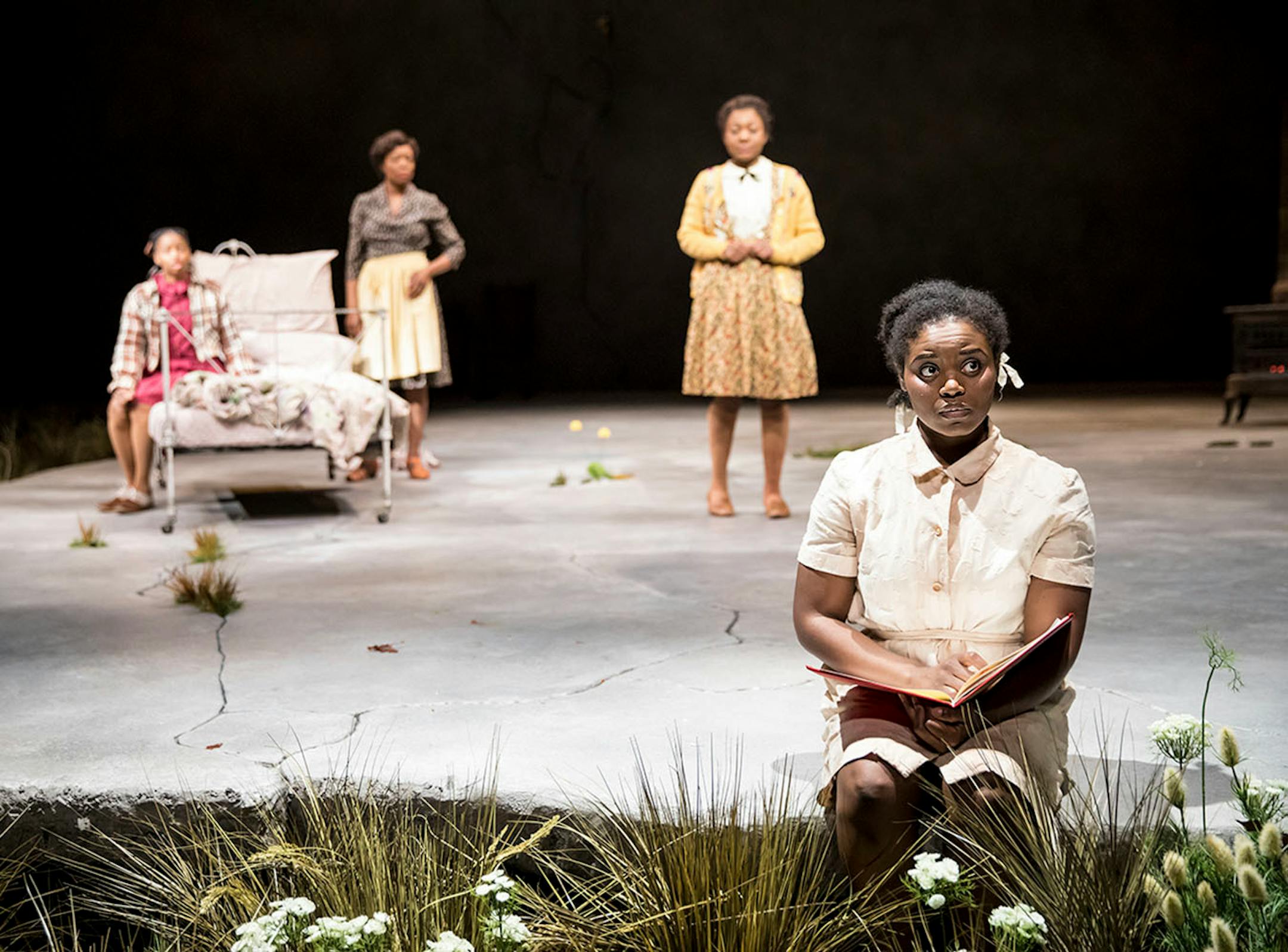 Brittany Bellizeare (Pecola), Carla Duren (Claudia), Regina Marie Williams (Mama) and Deonna Bouye (Frieda) in the Guthrie Theater's production of Toni Morrison's The Bluest Eye, adapted by Lydia R. Diamond and directed by Lileana Blain-Cruz.