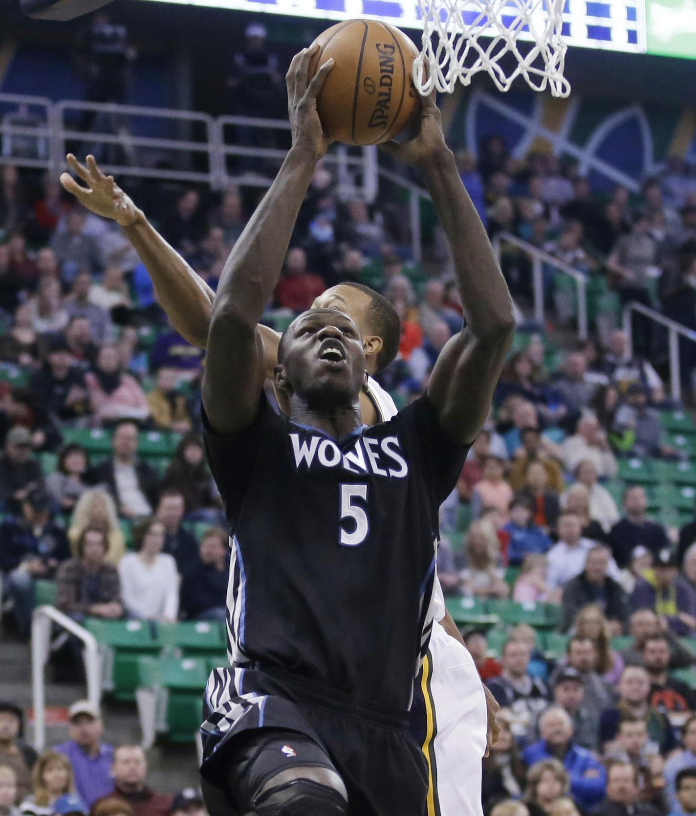 Minnesota Timberwolves center Gorgui Dieng (5) goes to the basket as Utah Jazz guard Rodney Hood, rear, defends during the first quarter in an NBA basketball game Friday, Jan. 29, 2016, in Salt Lake City. (AP Photo/Rick Bowmer)