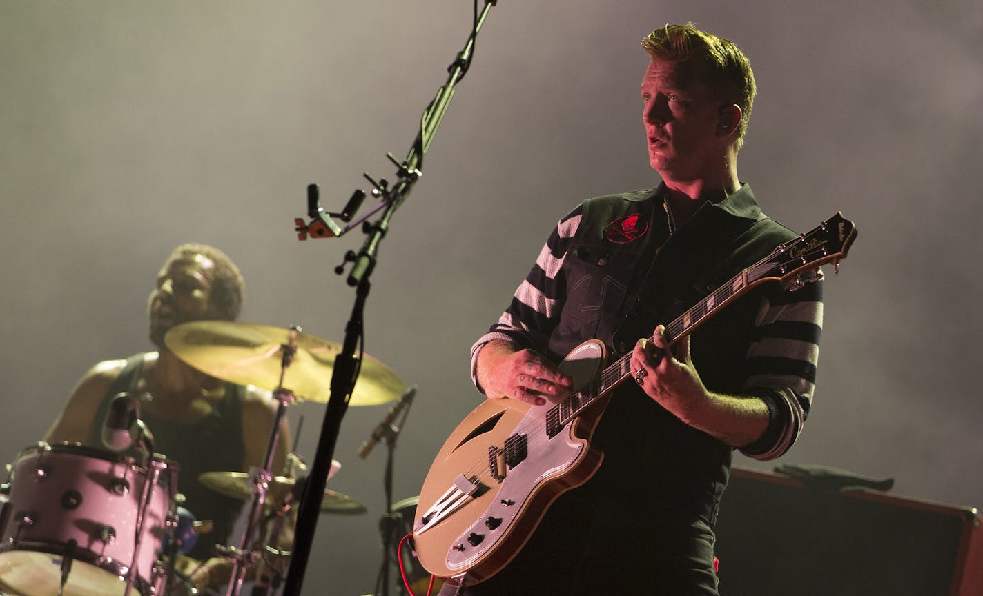 Musician Josh Hommer of the rock group Queens of the Stone Age performs at the Rock in Rio music festival in Rio de Janeiro, Brazil, Thursday, Sept. 24, 2015. (AP Photo/Leo Correa) ORG XMIT: XLC118